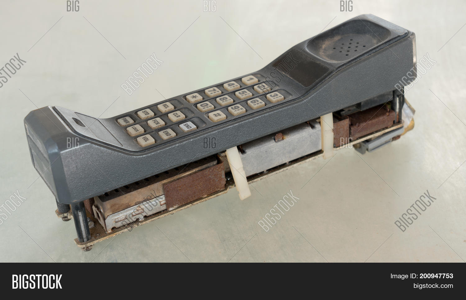 1980s,1G,2G,CDMA,GSM,analog,antenna,antique,audio,background,big,breakdown,brick,broken,business,cell,cellphone,cellular,communication,digital,dirty,electronic,equipment,first,generation,history,information,keypad,malfunction,mobile,nobody,number,object,old,phone,radio,retro,signal,style,system,technology,telephone,transmitting,vertical,vintage,waste,wireless