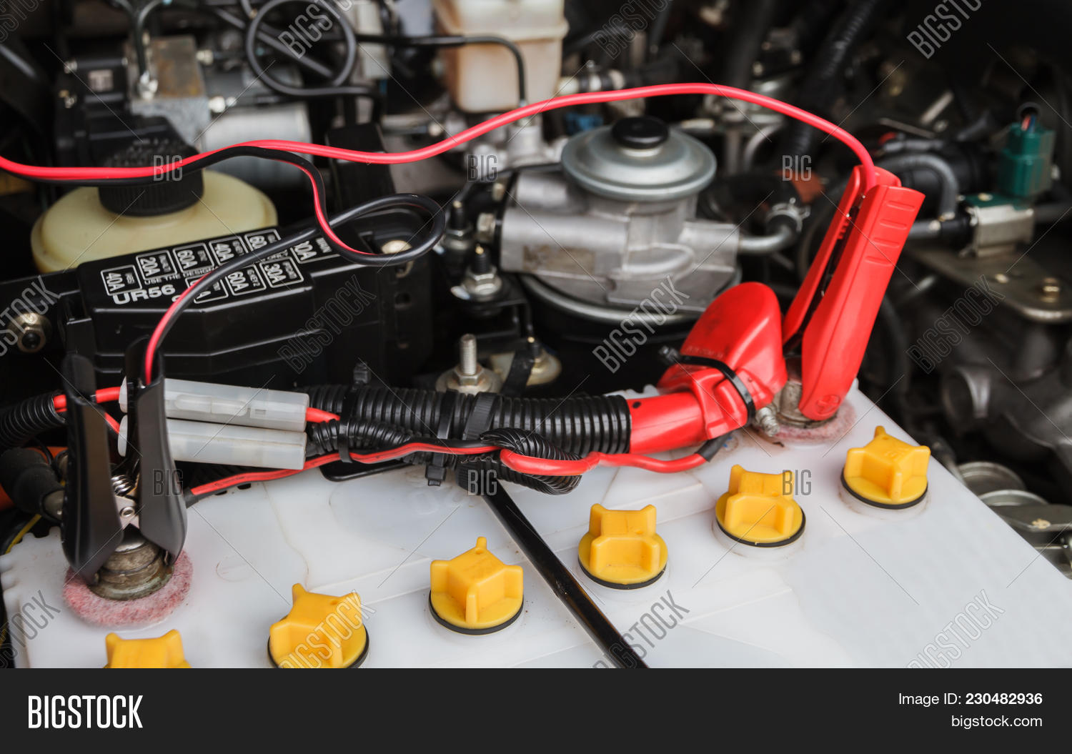 accessory,adapter,alligator,automobile,automotive,battery,black,cables,car,caucasian,checking,clamps,connector,coverall,dirty,disconnect,electricity,engine,fixing,flat,fuel,generation,grips,horizontal,jump,jumper,leads,line,maintenance,negative,one,photography,positive,power,problems,red,service,start,tool,transportation,vehicle,wire,working