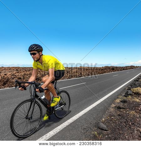 Road biking cyclist man training on bike professional cycling athlete ...
