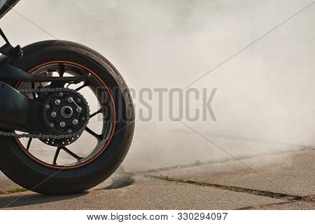 The Smoke Comes Out From Under The Wheels. Motorcycle Wheel Closeup ...