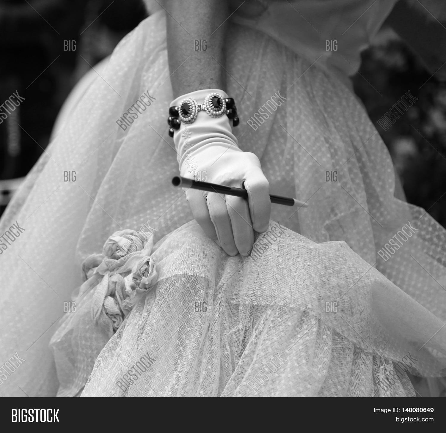 smoke,woman,habit,trick,vice,cigarette,lung,cancer,nicotine,drug,tobacco,mouthpiece,holder,vintage,retro,antique,ancient,old,40s,fur,hair,60,dress,bride,wedding,skirt,spoiled,50,costume,vesture,cloth,market,clothing,gown,glove,female,feminine,womanish,person,people,smoker