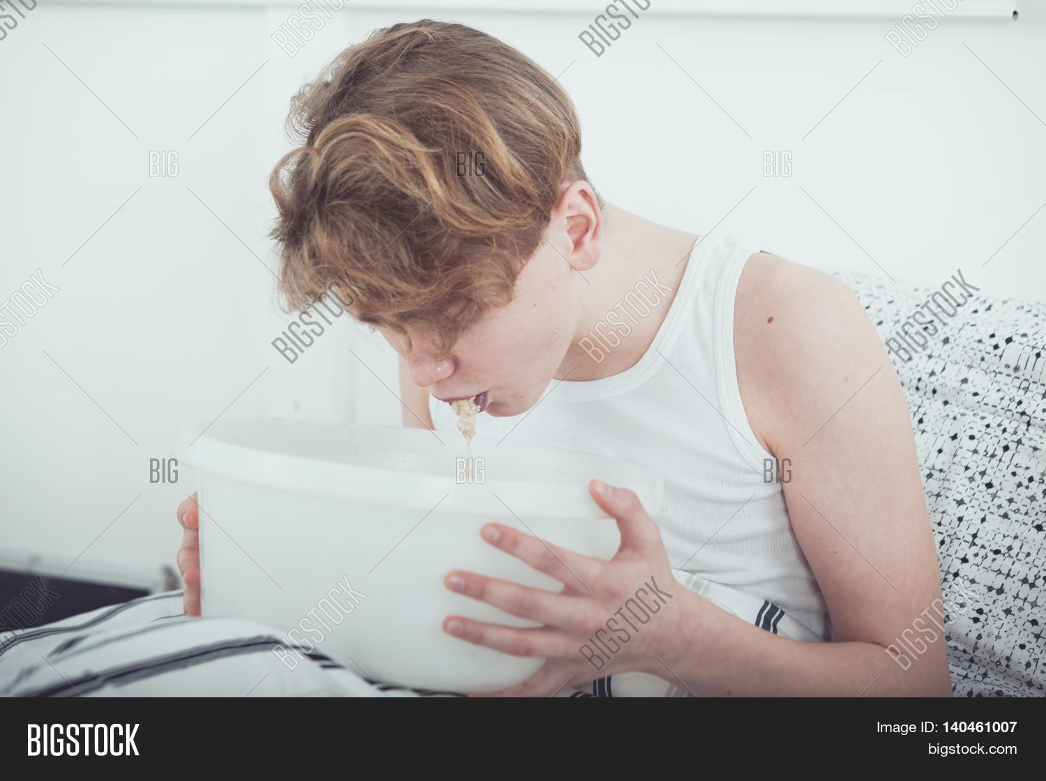 bed,boy,drunk,health,healthcare,ill,nausea,sick,teen,teenager,vomit,vomiting,patient,unwell,food,poisoning,suffering,symptom,puke,young,child,purge,disgorging,purging,basin,bowl,hurling,puking,allergic,reaction,regurgitating,medical,sitting,disease,stomach,kid,illness,wellness,lifestyle
