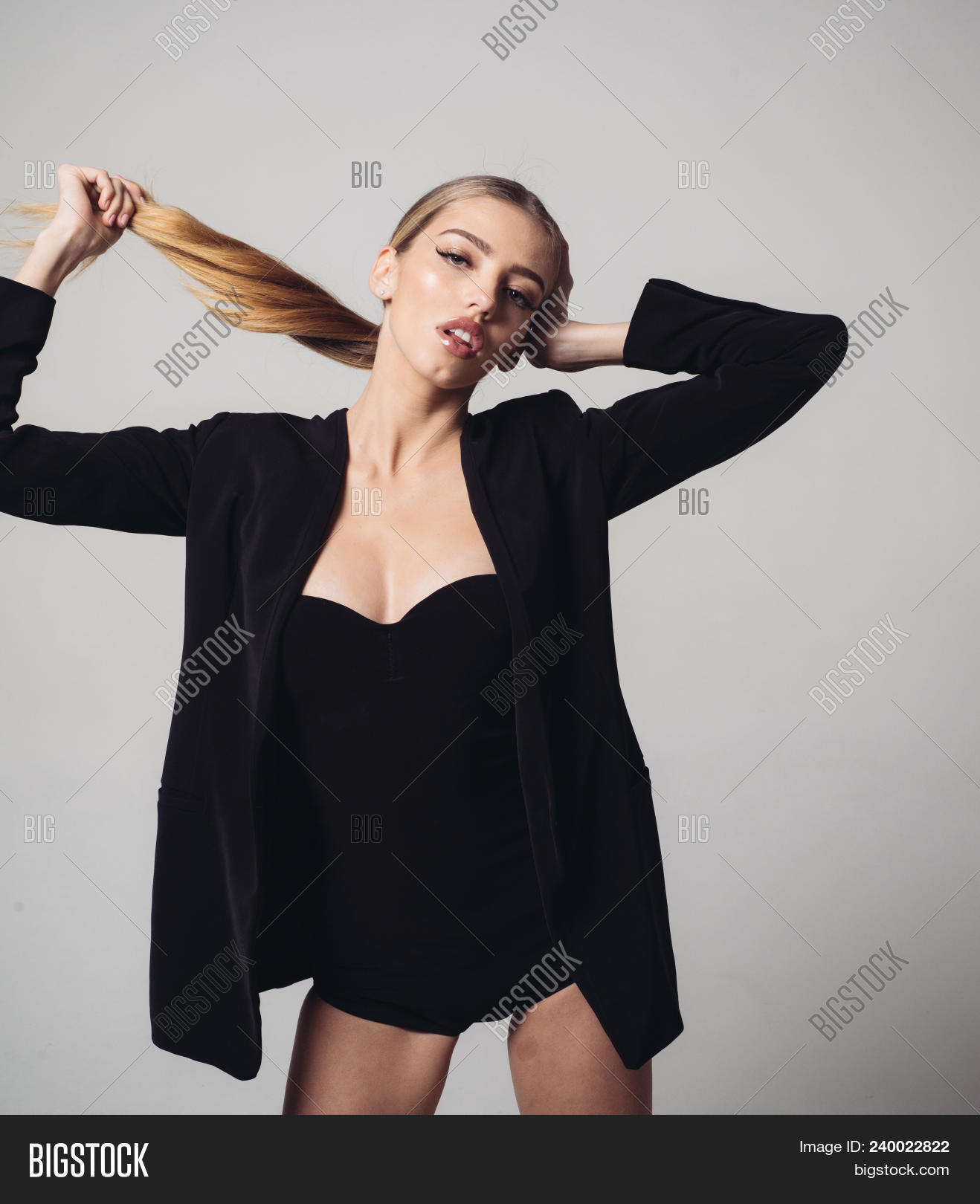 Girl In Formal Jacket And Sexy Decollete Play With Her Long