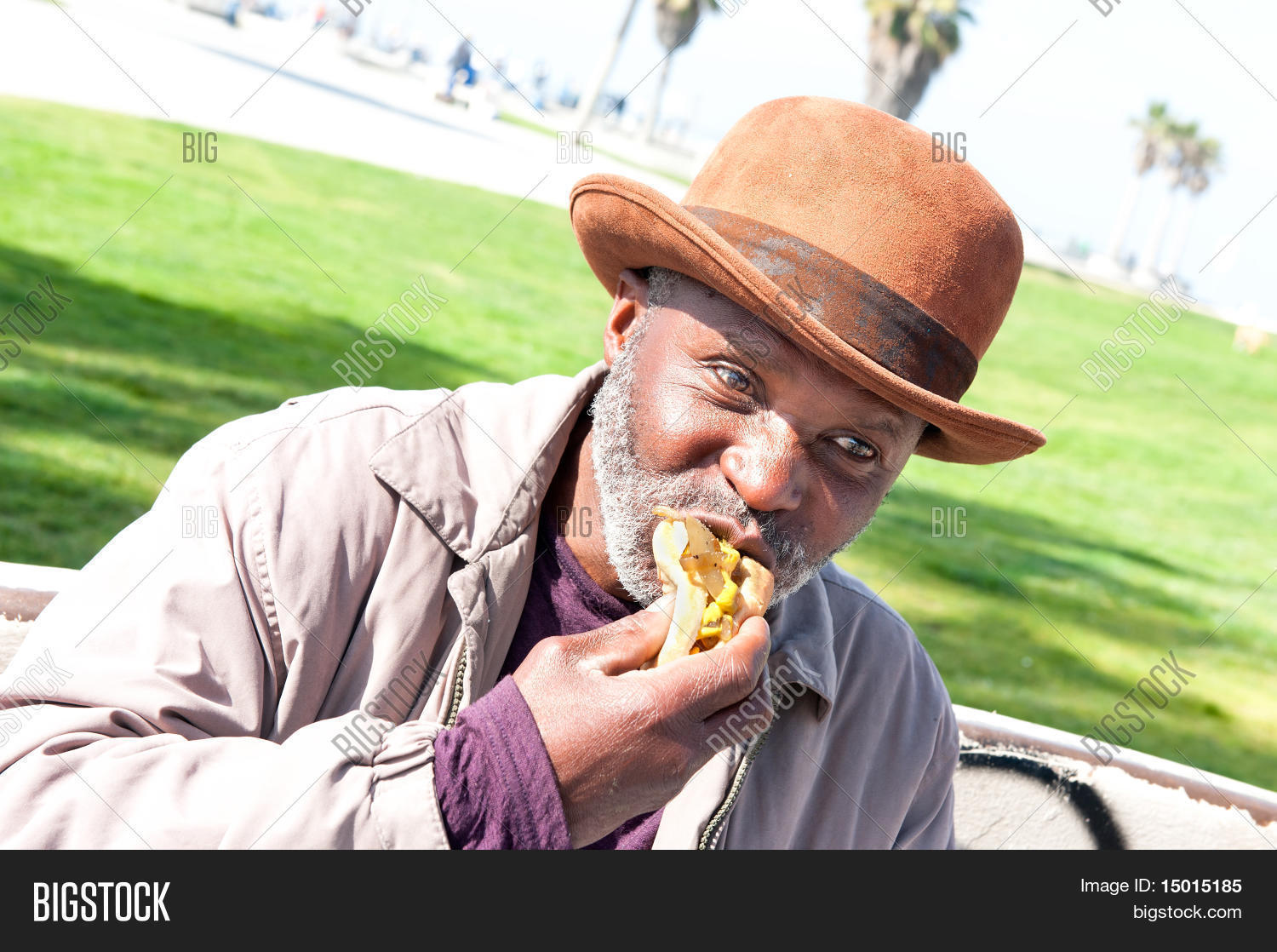 65,adult,african,alone,american,beard,biting,black,bun,color,consumption,daytime,derby,descent,eat,eating,elderly,enjoyment,ethnicity,face,food,friendly,gray,handsome,hat,homeless man,horizontal,human,image,individuality,male,man,men,mustard,old,one,onions,only,outdoors,park,people,person,photography,portrait,real,retired,scruffy,senior,unshaven,years