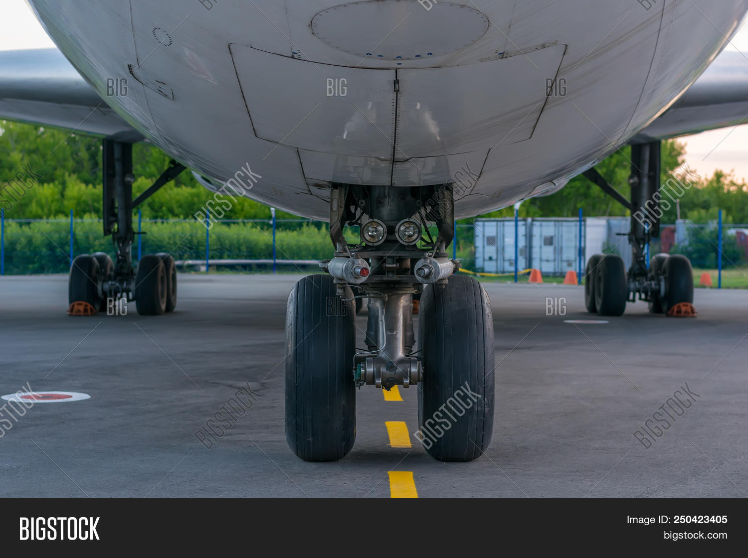 aeroplane,air,aircraft,airline,airliner,airplane,airport,airstrip,aviation,background,below,bottom,box,business,cargo,chassis,compartment,container,cover,fence,flight,fly,flying,freight,gear,goods,ground,hatch,hatchway,hedge,jet,lamp,landing,lane,lantern,lower,parking,part,plane,road,runway,sky,track,traffic,transport,transportation,travel,treadmill,walk,wheel