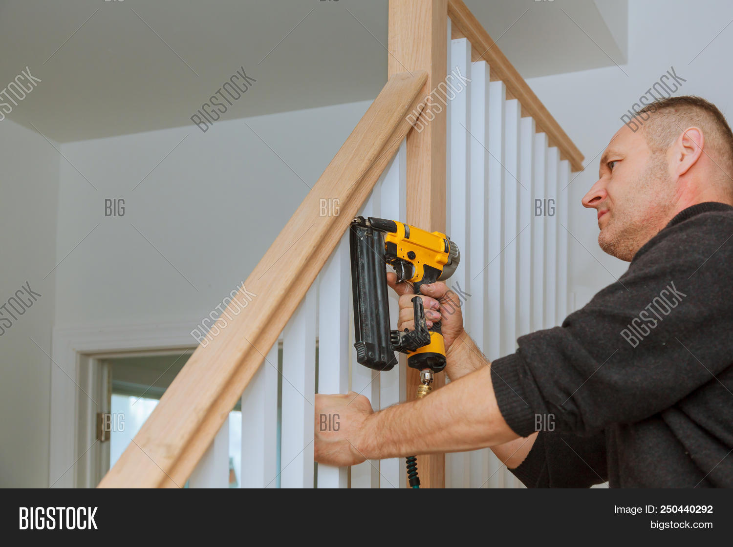 How To Install A Nailing The Railing For Stairs With An Air Gun image ...