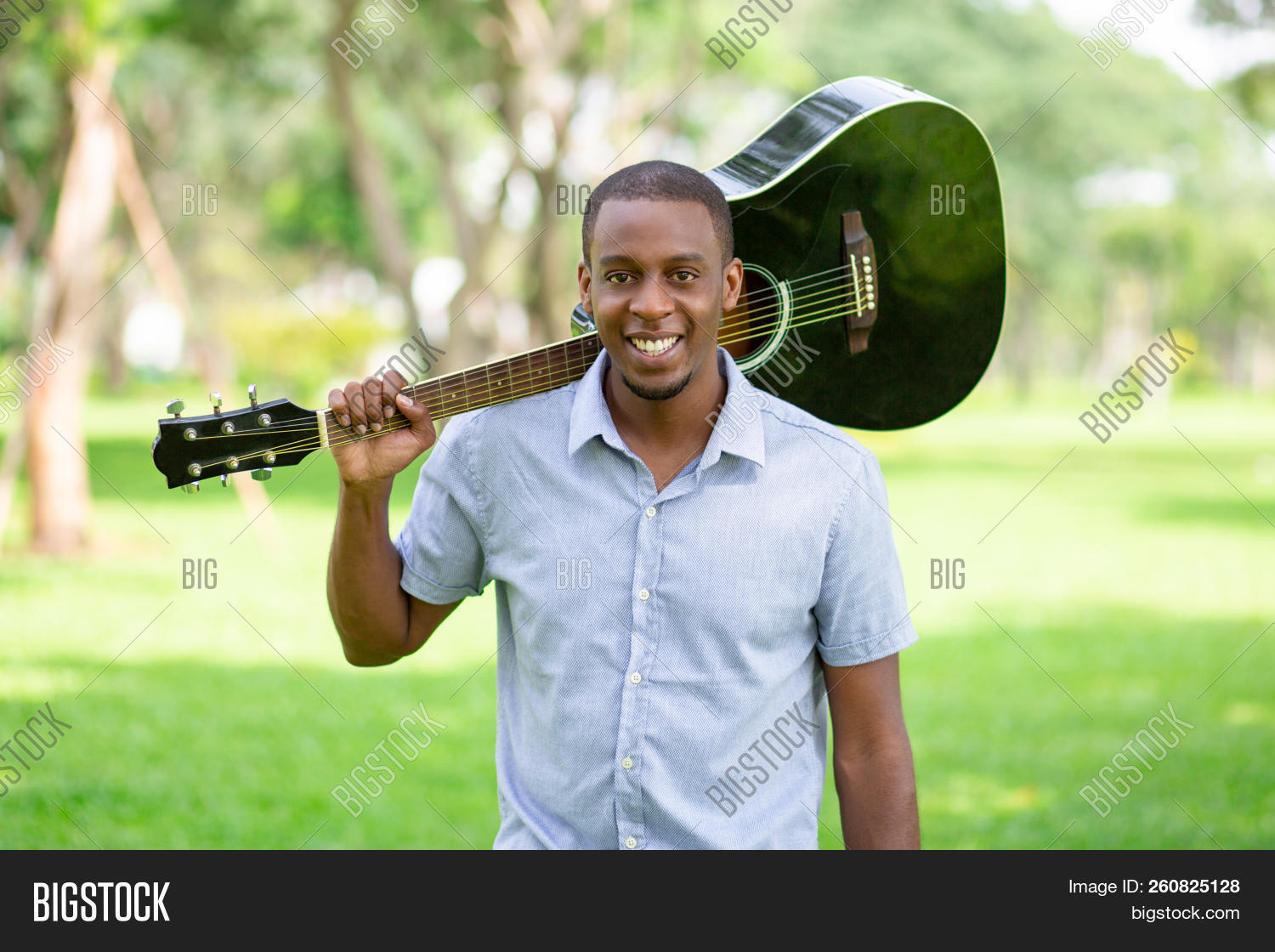 African,American,acoustic,adult,attractive,black,break,camera,casual,city,concept,fretboard,front,fun,grass,green,guitar,guitarist,guy,handsome,happy,holding,horizontal,instrument,leisure,lifestyle,looking,male,man,music,musical,musician,one,outdoor,park,performer,person,player,portrait,positive,rest,shirt,shoulder,smiling,standing,student,summer,tree,young
