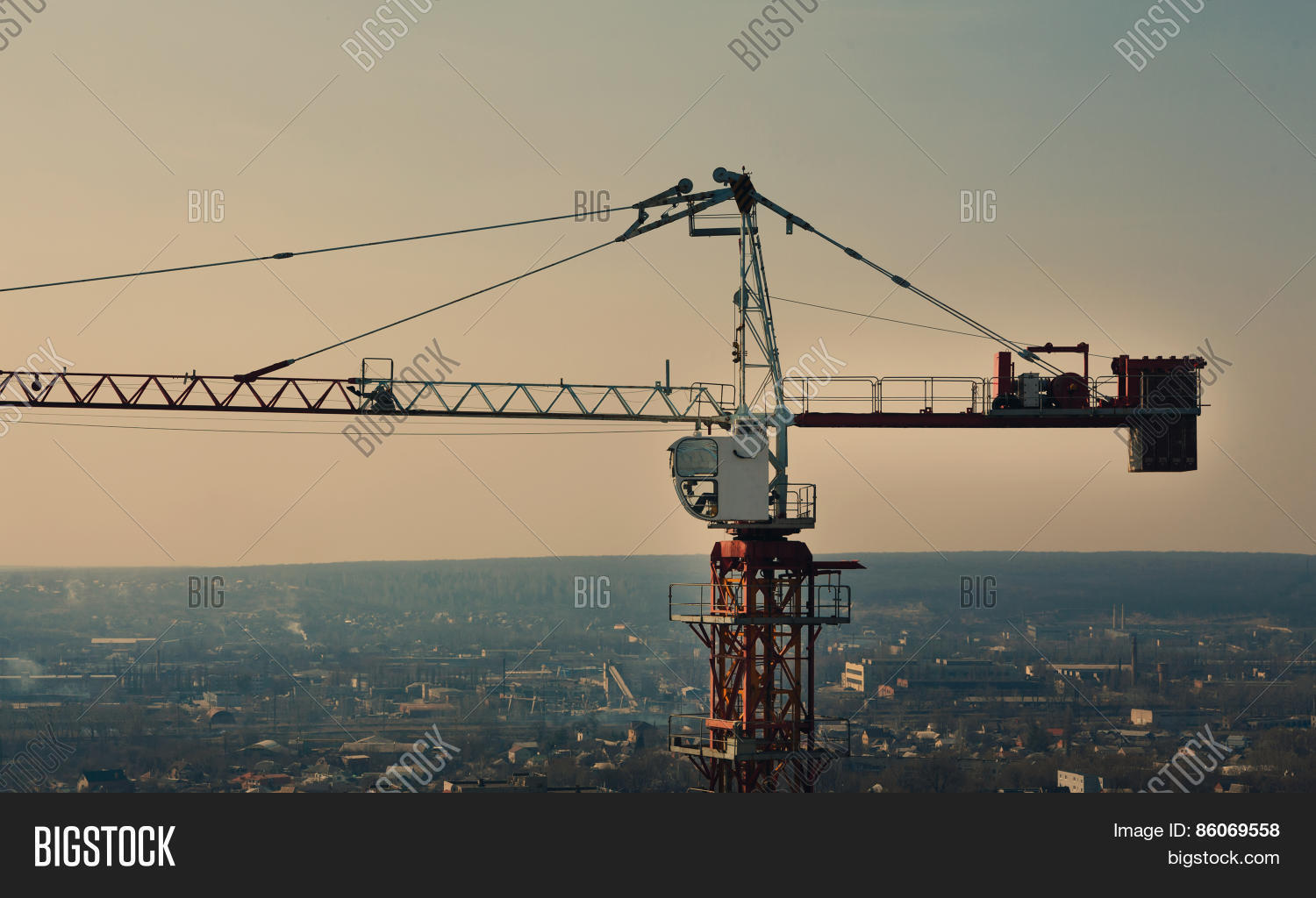 act,action,area,assemblage,assembling,assembly,blue,building,cabin,cargo,city,construction,counterweight,crane,detail,elevate,elevator,equipment,erection,evening,facility,heaviest,height,hoist,installation,jenny,jib,lift,light,load,machine,main,mechanism,mobile,mounting,operating,raise,set,silhouette,site,sky,structure,tower,urban,view,winch,work