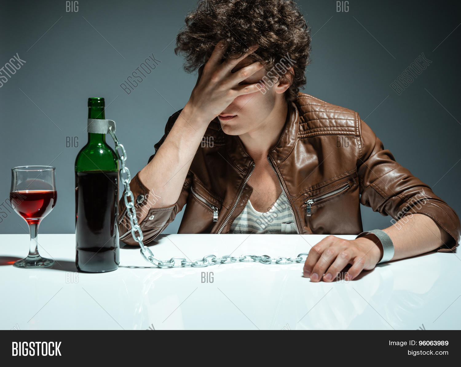 addiction,alcoholism,beverage,bibber,boozing,bottle,bound,boy,chain,confused,depressed,depressed man,despair,despond,dipsomania,dramatic,drink,drinker,drinking,drunk,drunkenness,emotional,fellow,fetter,frustration,fuddle,guy,handcuffs,harmful,heavy,hopeless,hopelessness,inebriated,inebriety,jacket,leather,loneliness,loser,man,penchant,problem,sad,sad man,sadness,solitude,stalemate,stressed,trouble,unhappy,unhealthy,upset,wine,wineglass,youth