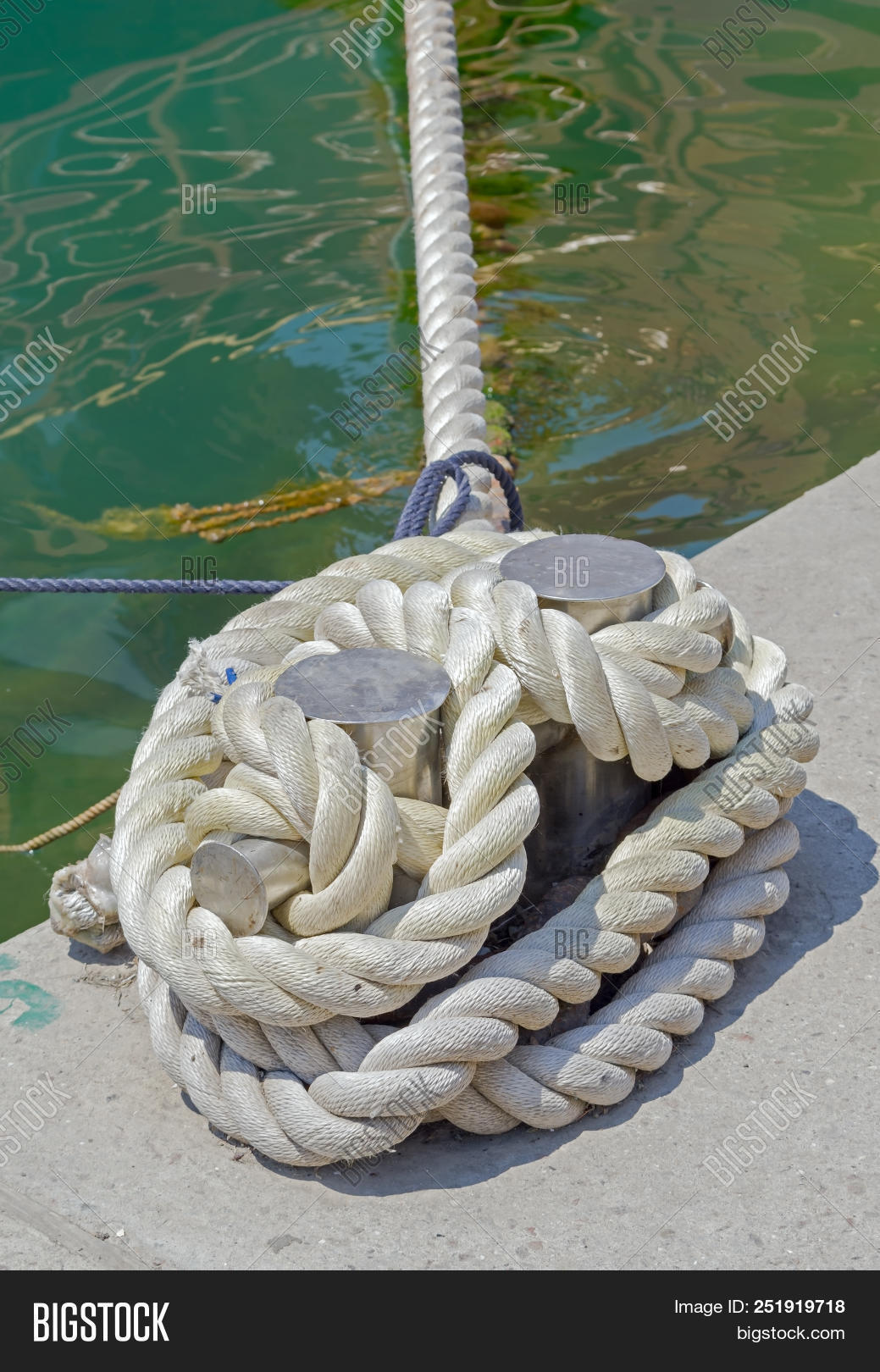 attached,boat,bollard,dock,harbor,iron,knot,line,marina,marine,maritime,metal,moor,moored,mooring,nautical,ocean,pier,port,quay,rope,sea,ship,tie,transport,transportation,travel,vessel,water,wharf