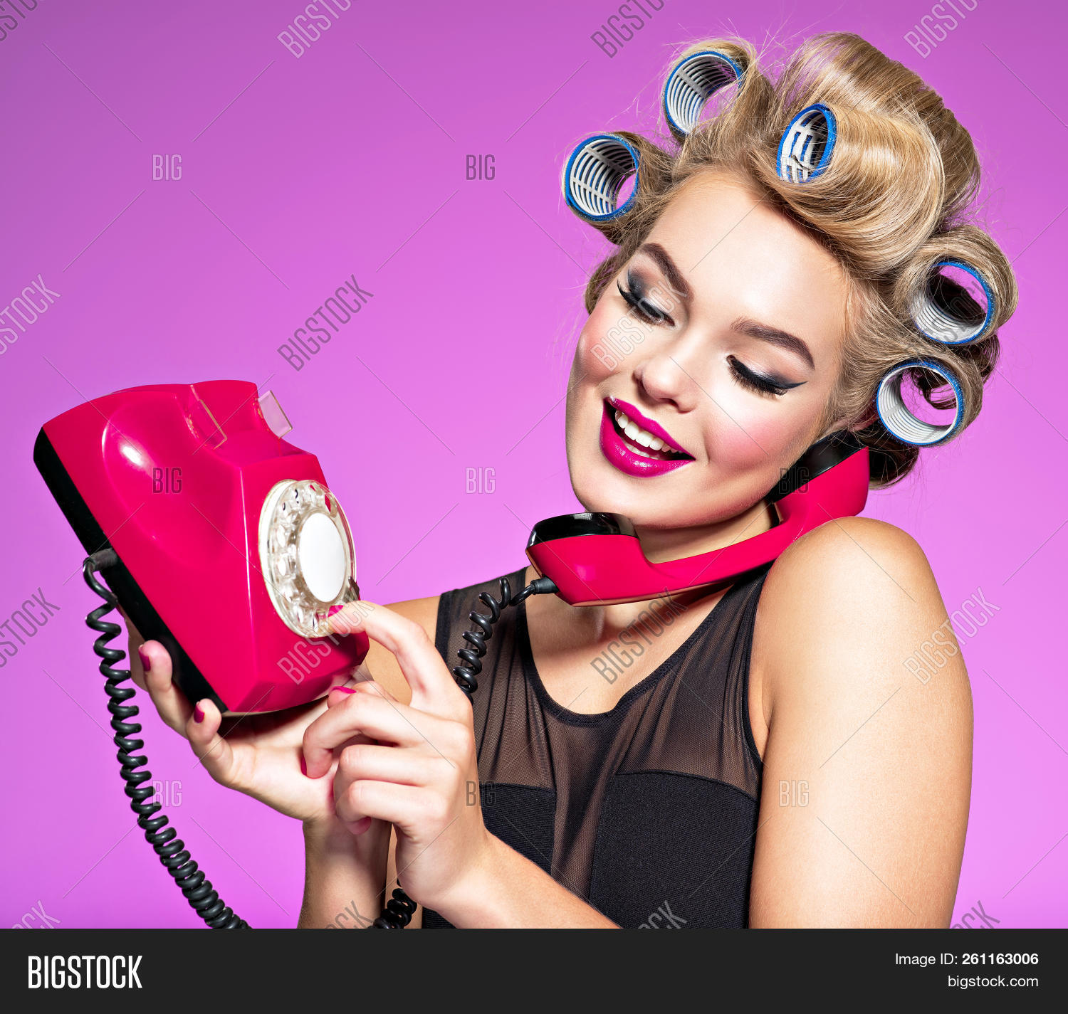 1950s,adult,attractive,background,beautiful,call,caucasian,cheerful,closeup,communication,curlers,dial,expression,fashion,female,funny,girl,glamour,hair,happy,looking,model,number,old,one,person,phone,pink,portrait,pretty,red,retro,smile,studio,style,talking,telephone,vintage,white,woman,young