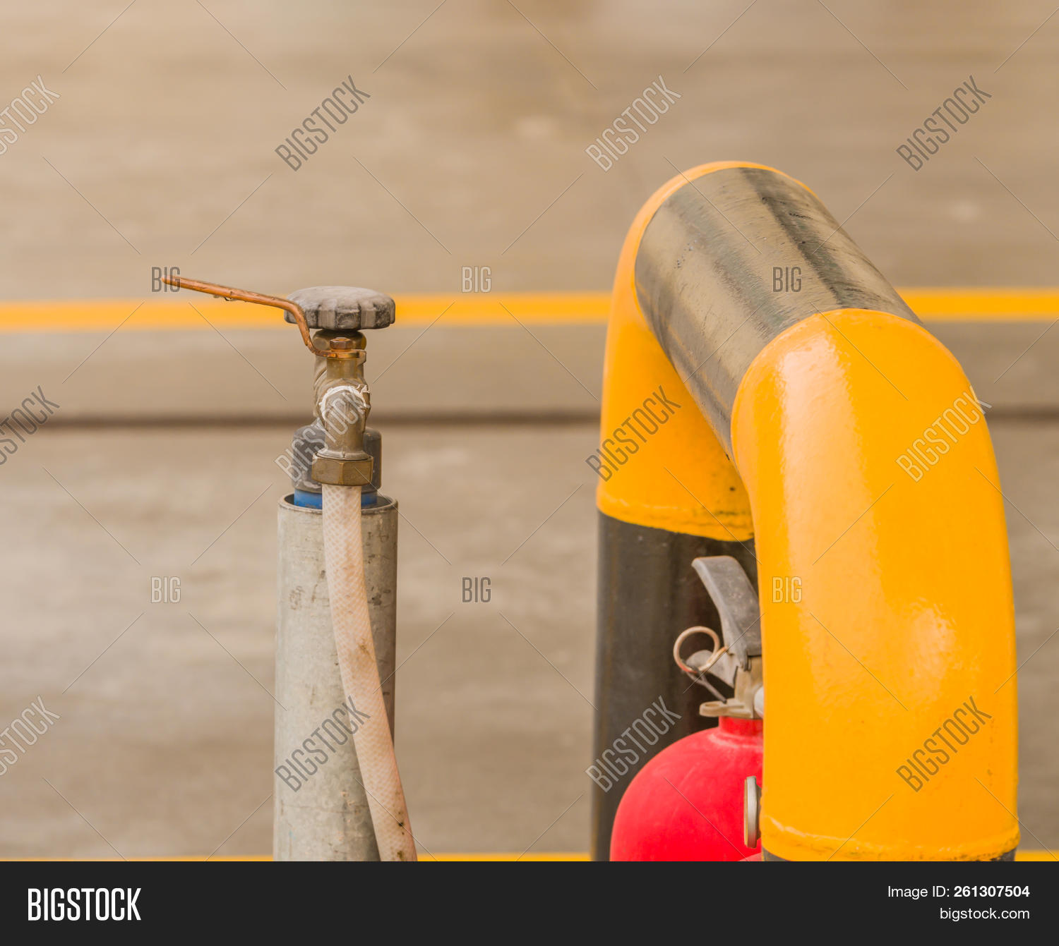 White Hose Attached To Water Faucet With A Pull Handle Next To