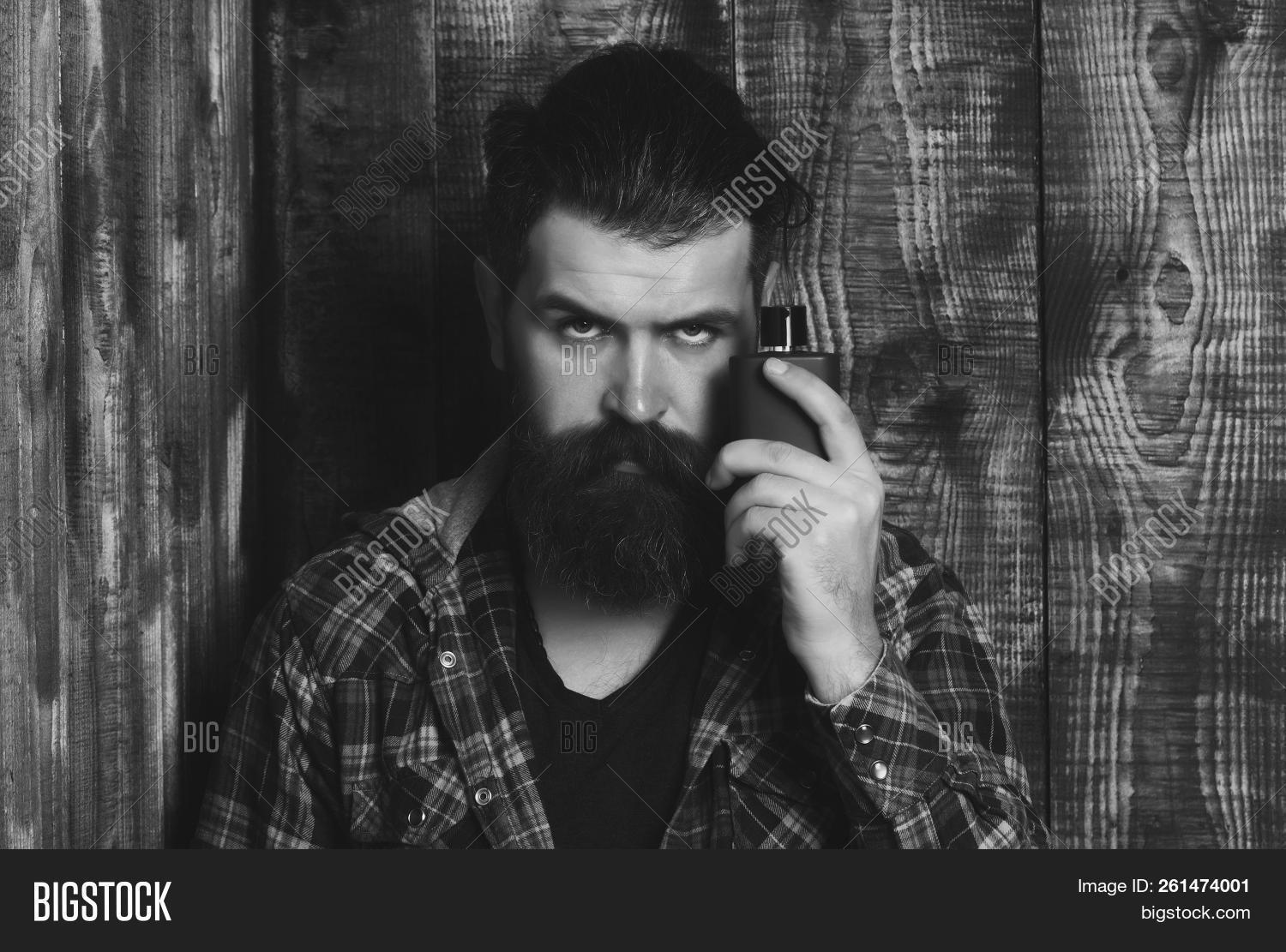 adult,aroma,background,beard,bearded,black,bottle,brutal,caucasian,cologne,cosmetics,fashion,fashionable,fragrance,grey,hair,hipster,hygiene,long,male,man,masculine,moustache,perfume,perfumery,posing,scent,stylish,toilet,unshaven,water,wooden