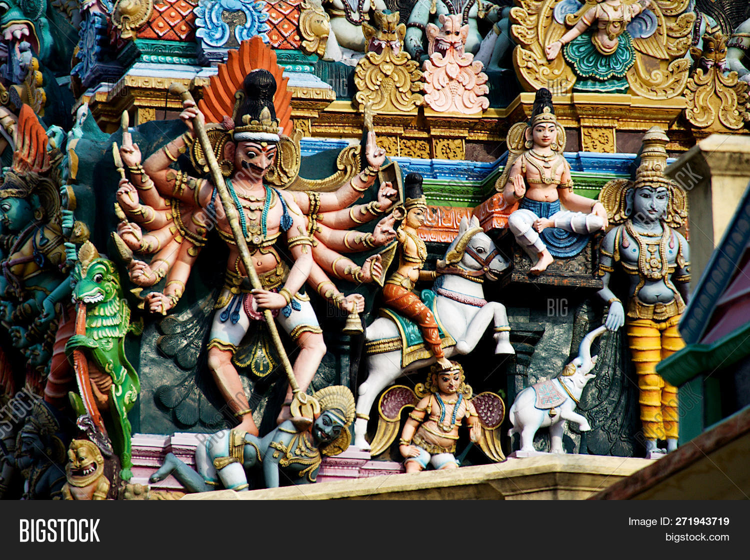Asia,India,Madurai,Meenakshi,Nadu,Tamil,Temple,carving,coated,decorated,demon,engraving,etching,figure,god,hands,horizontal,multiple,painted,place,sculpture,tour,tourist,travel,twelve
