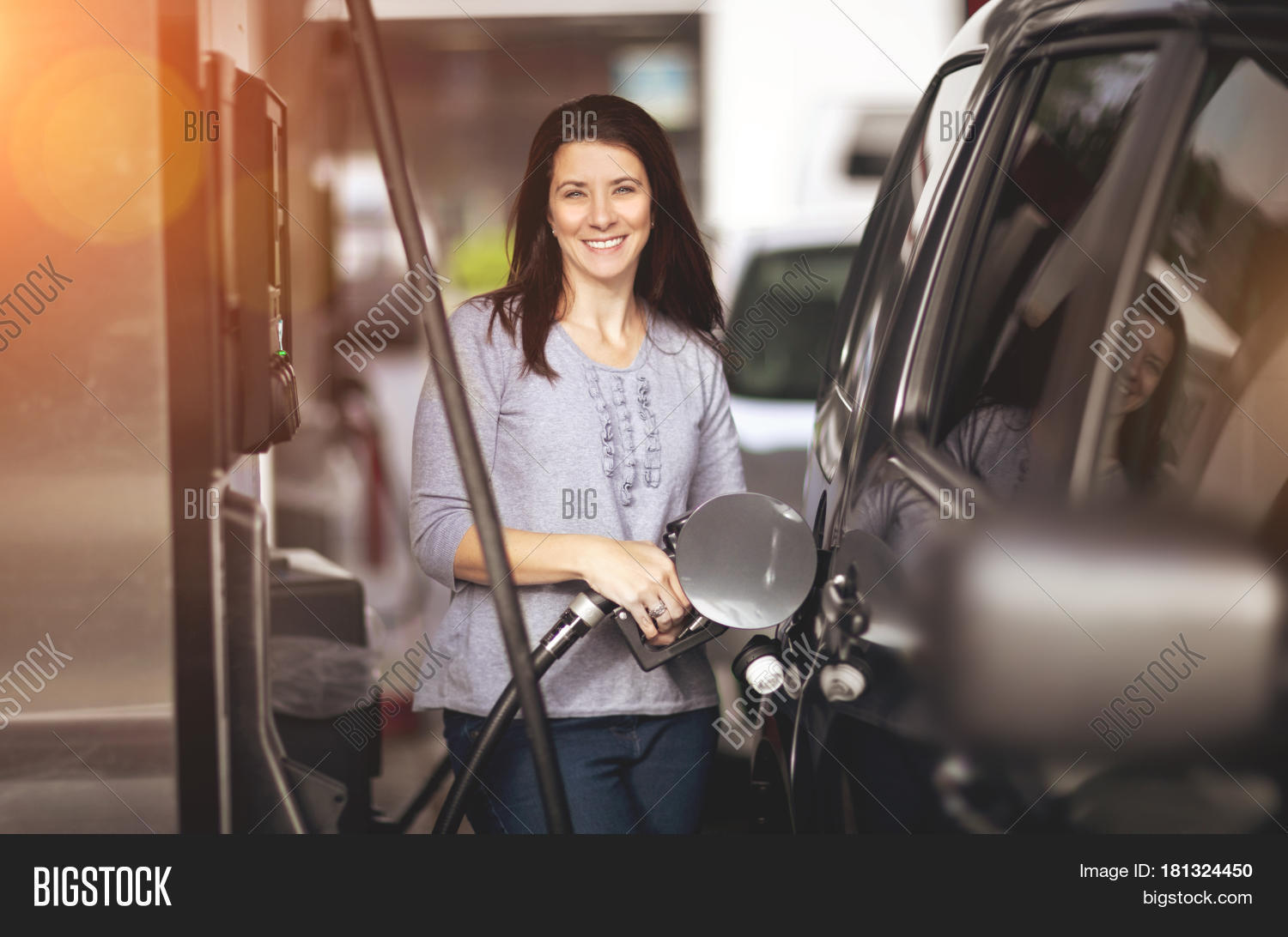 30,30-40,40,adult,beautiful,brunette,car,caucasian,concept,diesel,driver,expensive,filling,flare,forties,fuel,gas,gasoline,happy,jeans,mid-adult,motor,motorist,nozzle,one,person,petrol,pretty,pump,refuel,refueling,self,self-service,service,smiling,station,sun,sunny,suv,tank,thirties,woman