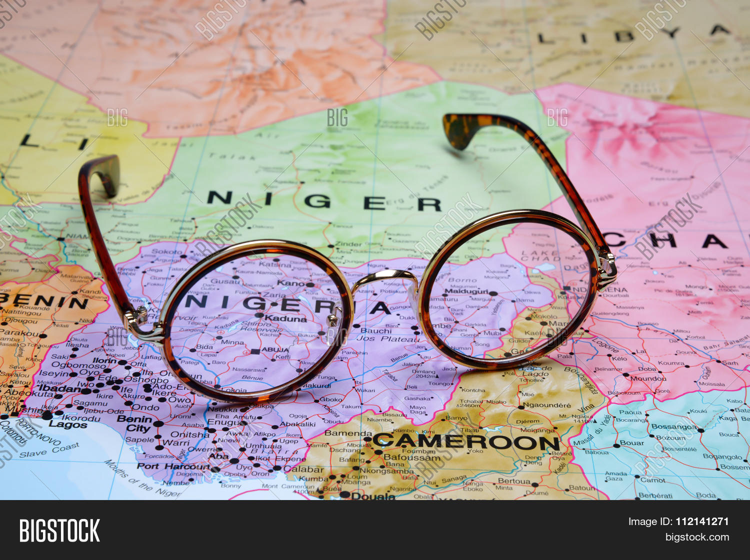 abuja,africa,atlas,background,business,capital,cartography,close-up,concept,countries,culture,destination,eyeglasses,geography,glasses,journey,lens,macro,magnifier,magnifying,map,nigeria,political,tourism,travel,view,world