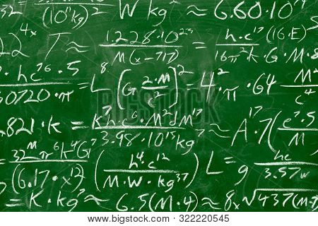 Math equations and formula written in chalk on green messy chalkboard background. School or scientif