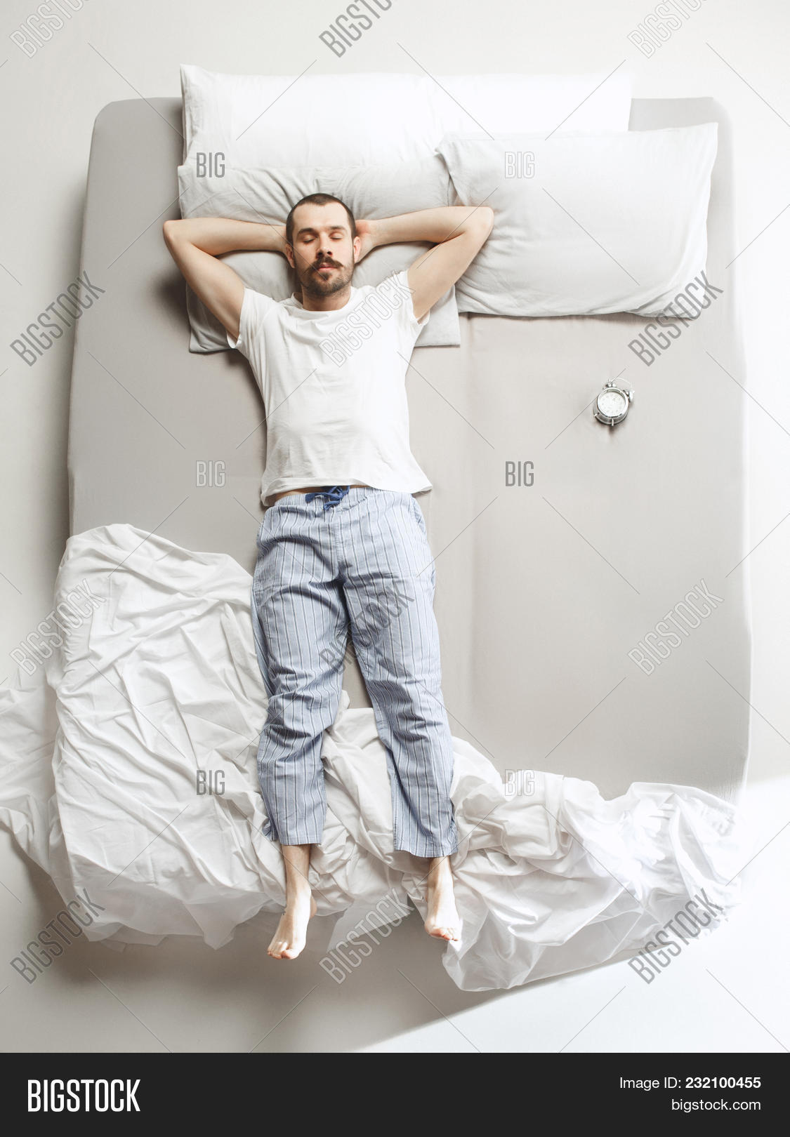 adult,alarm,bed,bedroom,bedtime,calm,clock,comfortable,concept,cozy,creativity,domestic,dreaming,emotions,expressing,good,grey,handsome,happy,ideas,indoors,lifestyle,lying,male,man,men,morning,night,one,people,person,pillow,portrait,positivity,relaxation,resting,satisfaction,sheet,sleep,sleeping,technology,top,tranquil,unwillingness,up,view,wake,white,young