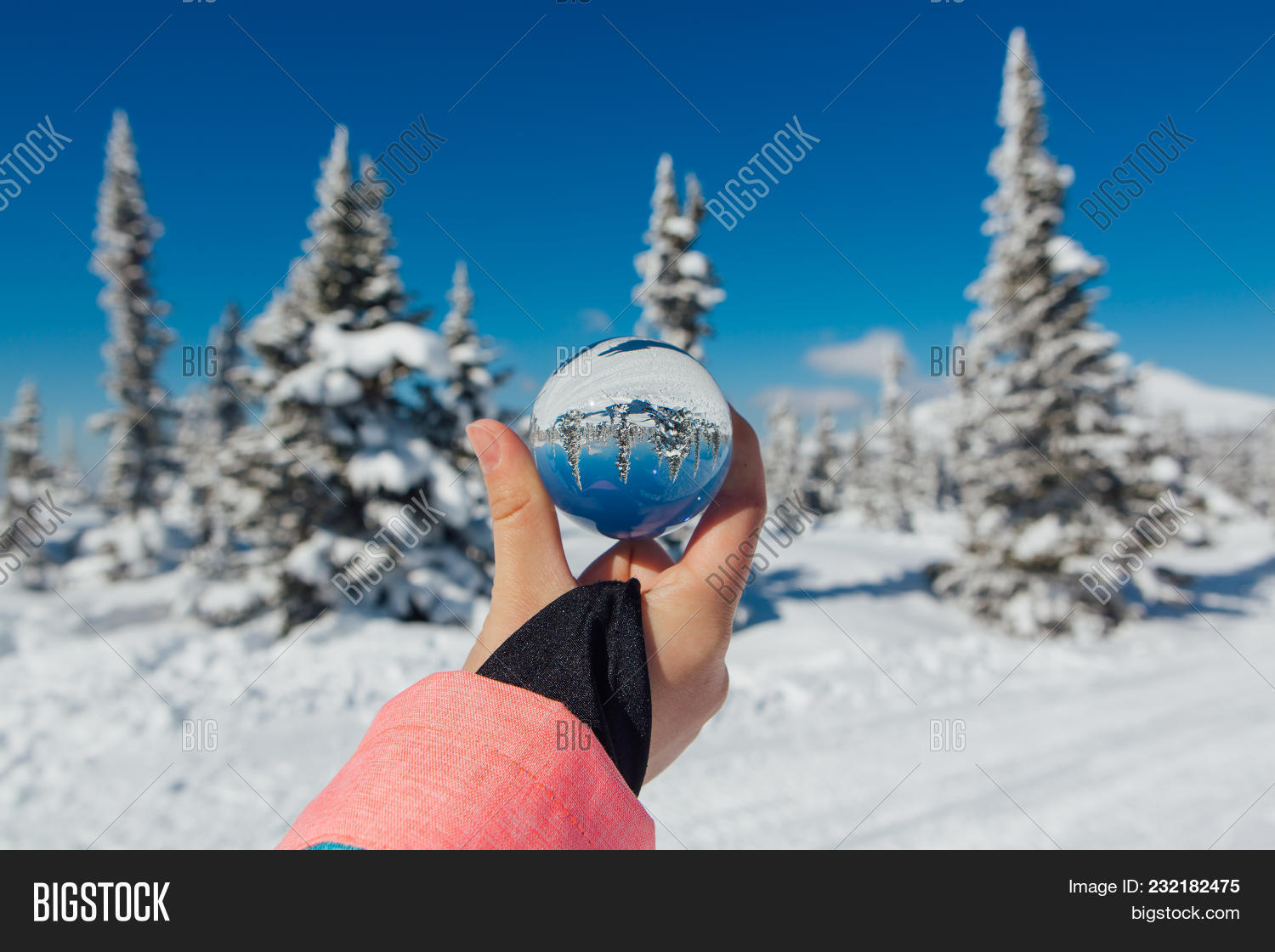 Transparent Glass Ball Reflecting A Frozen Winter Landscape