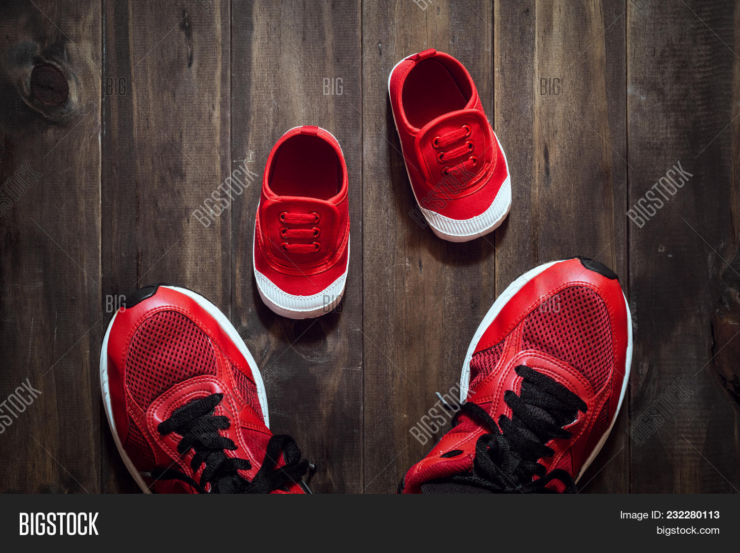 Two Red Sport Running Shoes Or Sneakers Of Mother Or Father And Child On Wooden Background Use For F 232280113 Image Stock Photo