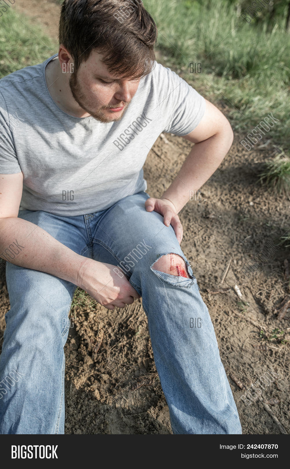 20-29,accident,adult,against,aid,background,bleeding,blood,body,bruise,care,caucasian,child,closeup,drop,fell,heal,health,help,hospital,human,hurt,injured,injury,jeans,knee,leg,male,man,medical,medicine,outdoors,outside,pain,painful,patient,people,person,red,scrape,skin,sport,torn,treatment,wound,years,young