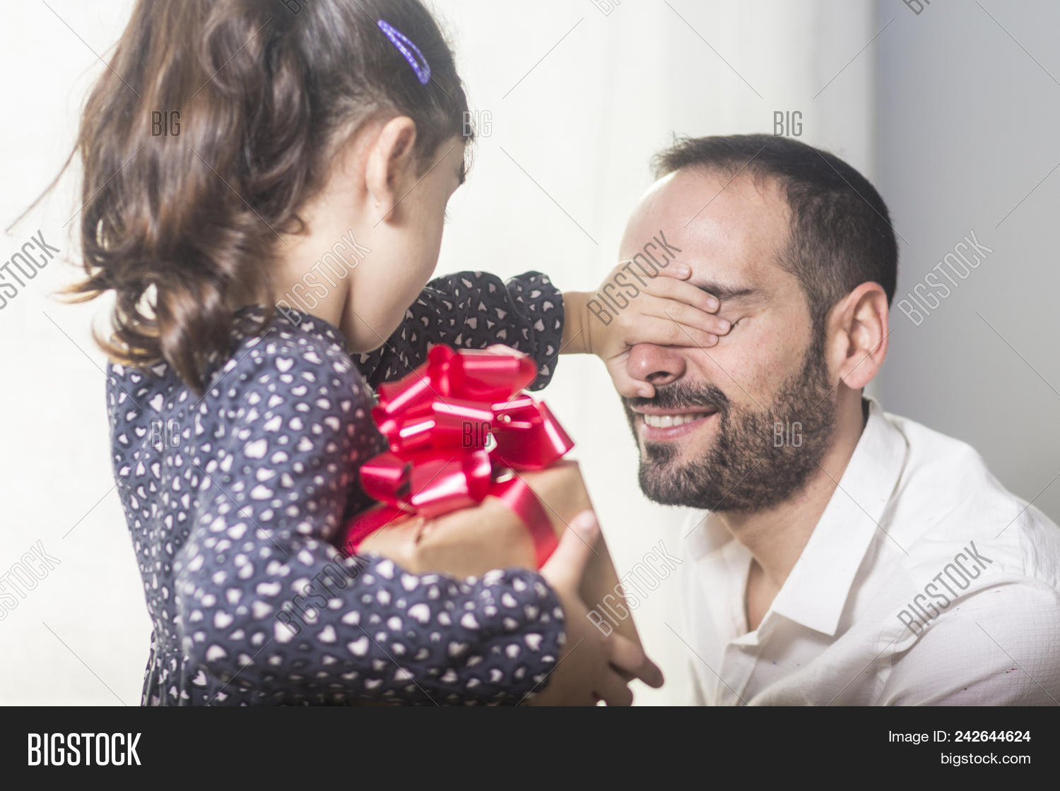 abode,adult,apartment,beard,bonding,box,bright,casual,caucasian,child,childhood,clothing,covering,cute,daughter,day,domestic,family,father,female,focus,foreground,gift,girl,happiness,hiding,holding,home,homey,house,indoors,life,lifestyle,love,male,man,mid,on,one,parent,side,sitting,smiling,standing,surprise,togetherness,view