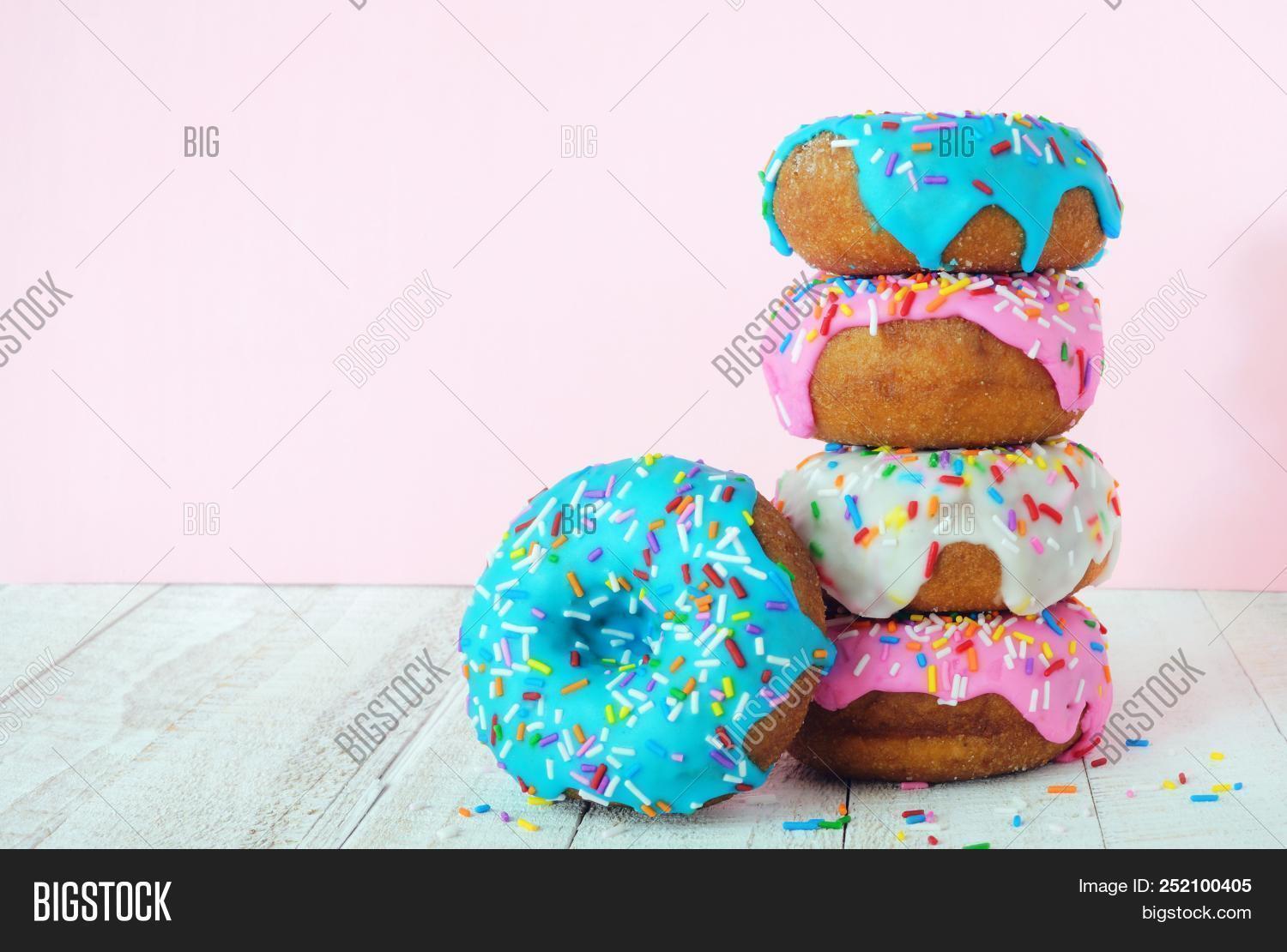 assortment,baby,background,baked,blue,bold,bright,cake,candy,color,colorful,decoration,delicious,dessert,donuts,eating,food,frosted,frosting,glaze,glazed,group,holiday,icing,pastel,pastry,pink,set,side,snack,spring,sprinkles,stack,stacked,sugar,sugary,sweet,tasty,tower,treat,unhealthy,variety,various,vibrant,view,white,wood,wooden