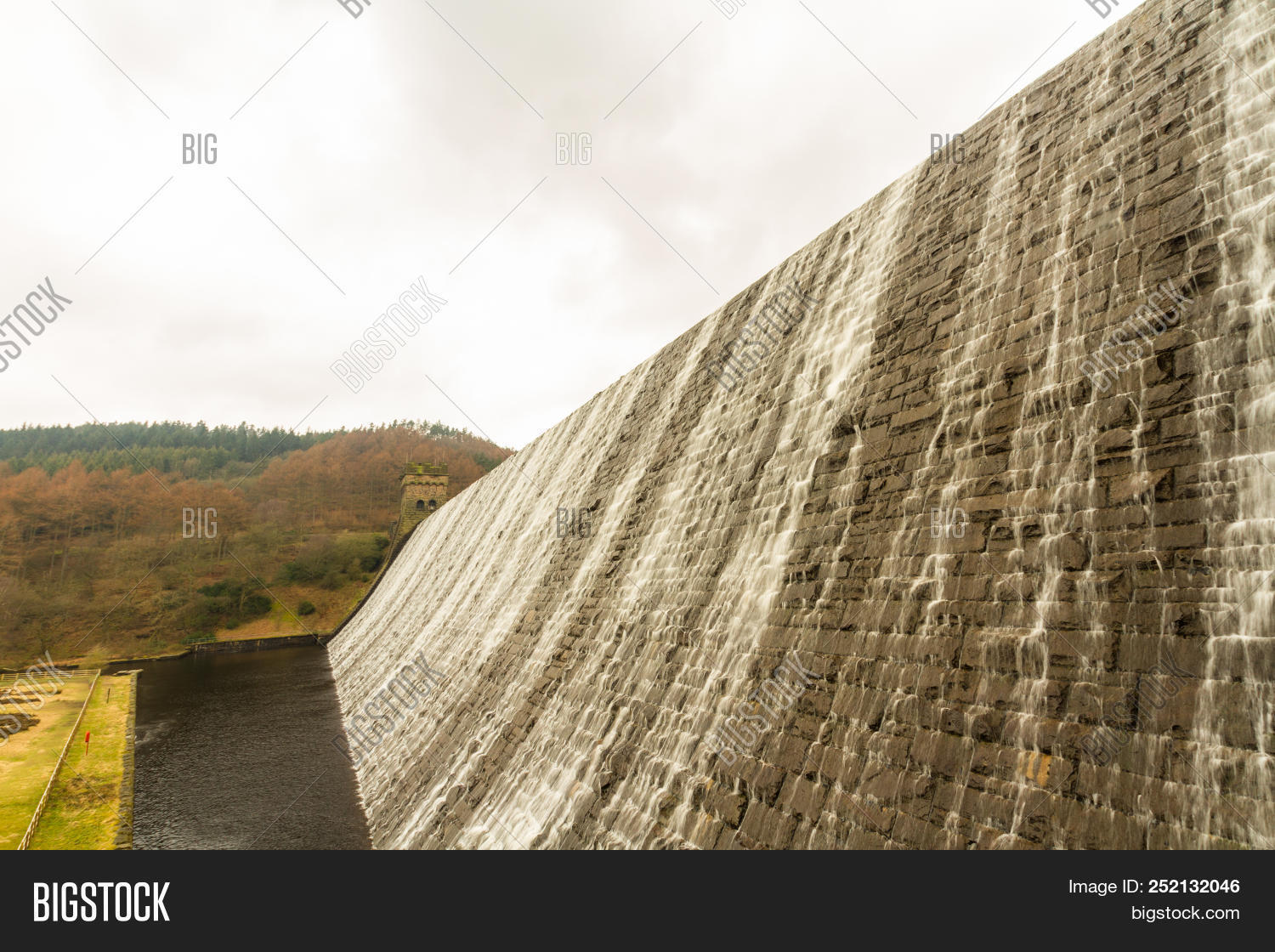 Water Cascading Down Stone Dam Ladybower Reservoir