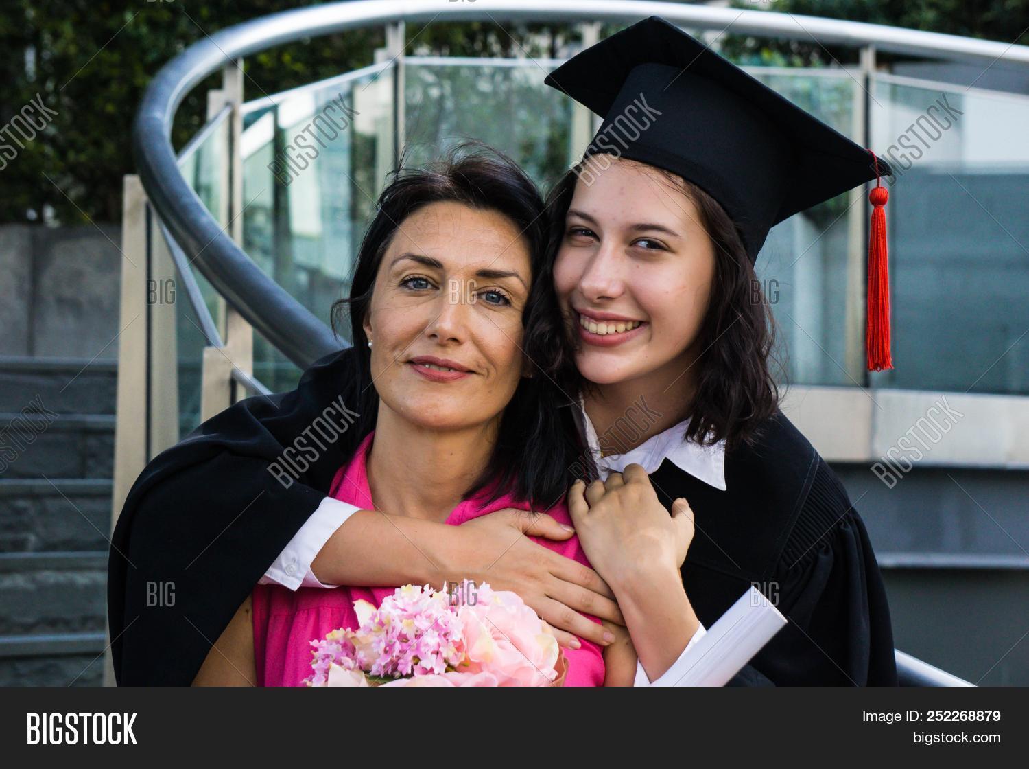 academic,achievement,adult,asia,asian,attractive,bachelor,background,beautiful,cap,caucasian,celebration,ceremony,certificate,college,daughter,day,degree,diploma,education,excited,family,female,girl,gown,graduate,graduation,happiness,happy,hat,hug,hugging,lifestyle,love,mom,mother,outdoors,parents,people,person,portrait,pretty,school,smile,student,success,university,white,woman,young