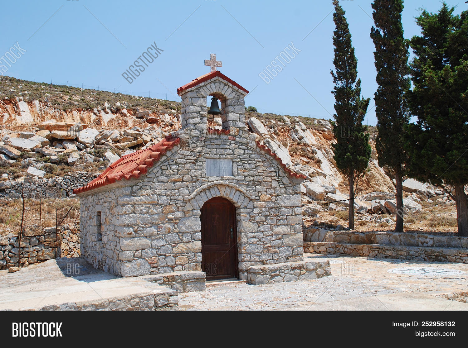 aegean,architecture,bell,building,chapel,christian,christianity,church,day,dodecanese,europe,european,exterior,greece,greek,hill,island,mediterranean,nobody,orthodox,outdoors,religion,road,small,stone,summer,tilos,tourism,travel,worship