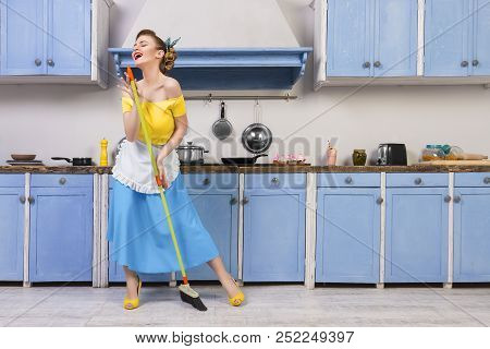 Retro Pin Up Girl Woman Female Housewife Wearing Colorful Top, Skirt And White Apron Holding Cooked