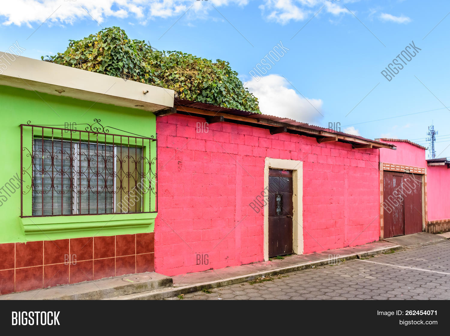 America,Central,Guatemala,Latin,aluminium,aluminum,architecture,bars,brick,building,cobbled,cobblestones,color,colored,colorful,corrugated,cottage,culture,door,doorway,entrance,entranceway,exterior,facade,green,guatemalan,house,iron,ironwork,metal,metalwork,outdoors,outside,painted,pink,plain,road,rural,simple,single,storey,street,tin,town,travel,village,wall,window