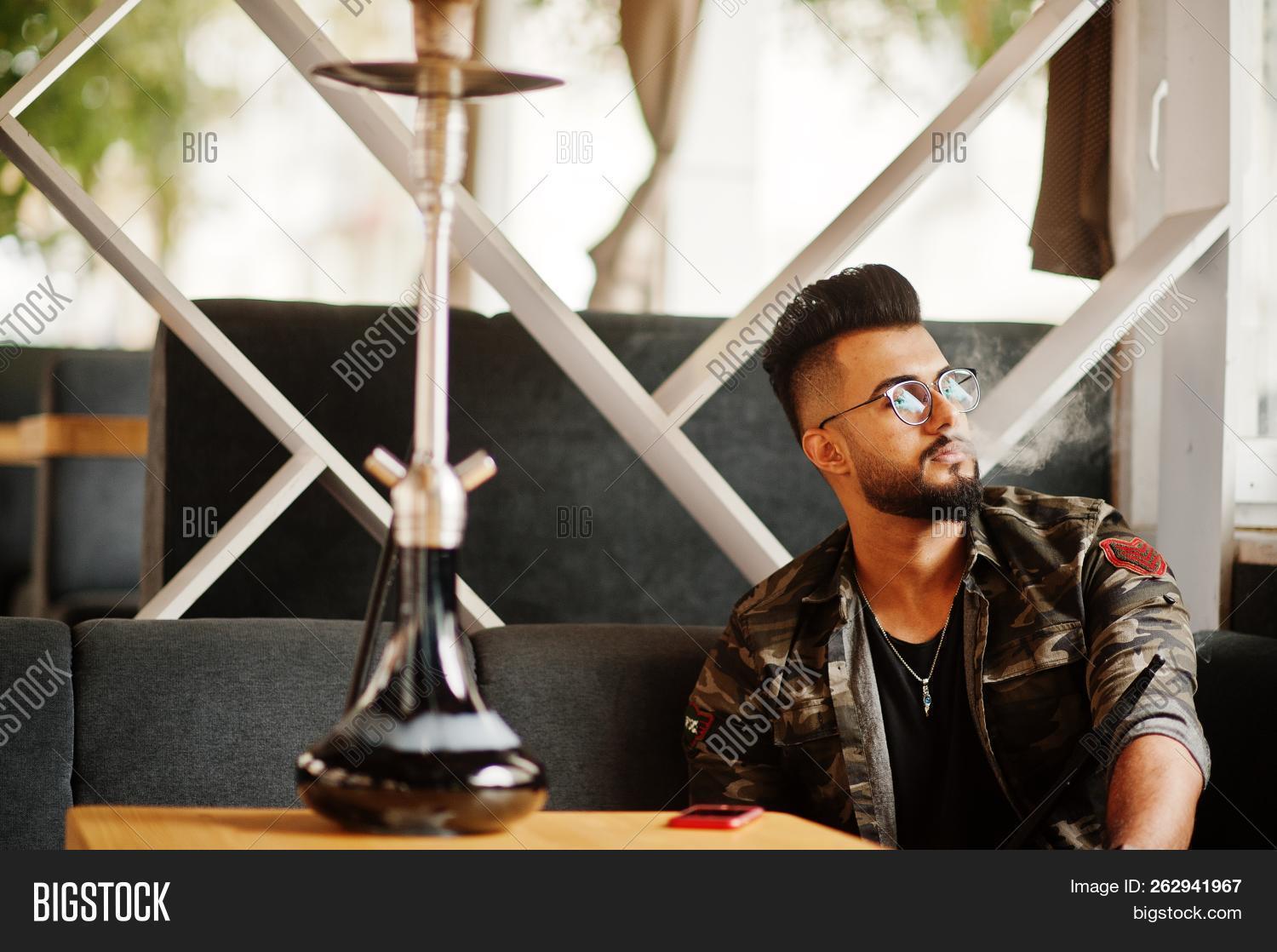 arab,arabia,arabian,arabic,beard,black,cafe,cafeteria,charcoal,culture,dubai,east,ethnicity,glasses,guy,handsome,hooka,hookah,iran,iraq,istanbul,leisure,macho,male,man,military,model,muslim,narcotic,narghile,nargila,nargile,nicotine,one,portrait,relaxation,relaxing,saudi,shisha,smoke,smoker,tall,tobacco,traditional,travel,turkey,turkish,uae,young
