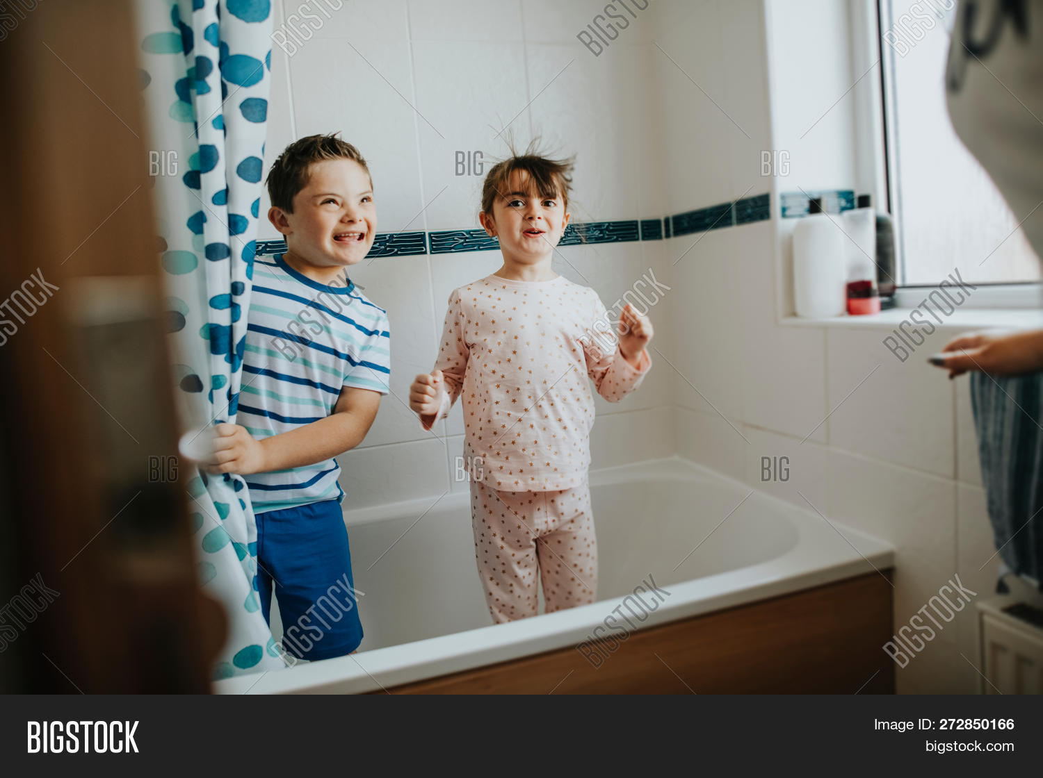 bathroom,bathtub,blue,boy,brother,child,childhood,disabled,dots,down syndrome,elementary age,happiness,happy,intellectual disability,kid,morning,pajamas,peekaboo,play,playful,polka dot,shower,shower curtain,siblings,sister,smiling,surprise,together,trisomy 21,tub,young