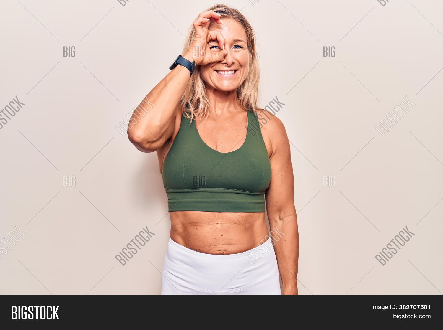 approve, 																					athlete, 																					binoculars, 																					blonde, 																					camera, 																					casual, 																					caucasian, 																					cheerful, 																					clothes, 																					confident, 																					doing, 																					expression, 																					eyes, 																					face, 																					female, 																					finger, 																					fingers, 																					fit, 																					fitness, 																					fun, 																					gesture, 																					gym, 																					hand, 																					happiness, 																					happy, 																					healthy, 																					hole, 																					humor, 																					look, 																					looking, 																					middle age, 																					muscle, 																					ok, 																					person, 																					positive, 																					sign, 																					smile, 																					smiling, 																					sport, 																					sportswear, 																					sporty, 																					surprise, 																					through, 																					training, 																					view, 																					vision, 																					woman, 																					workout