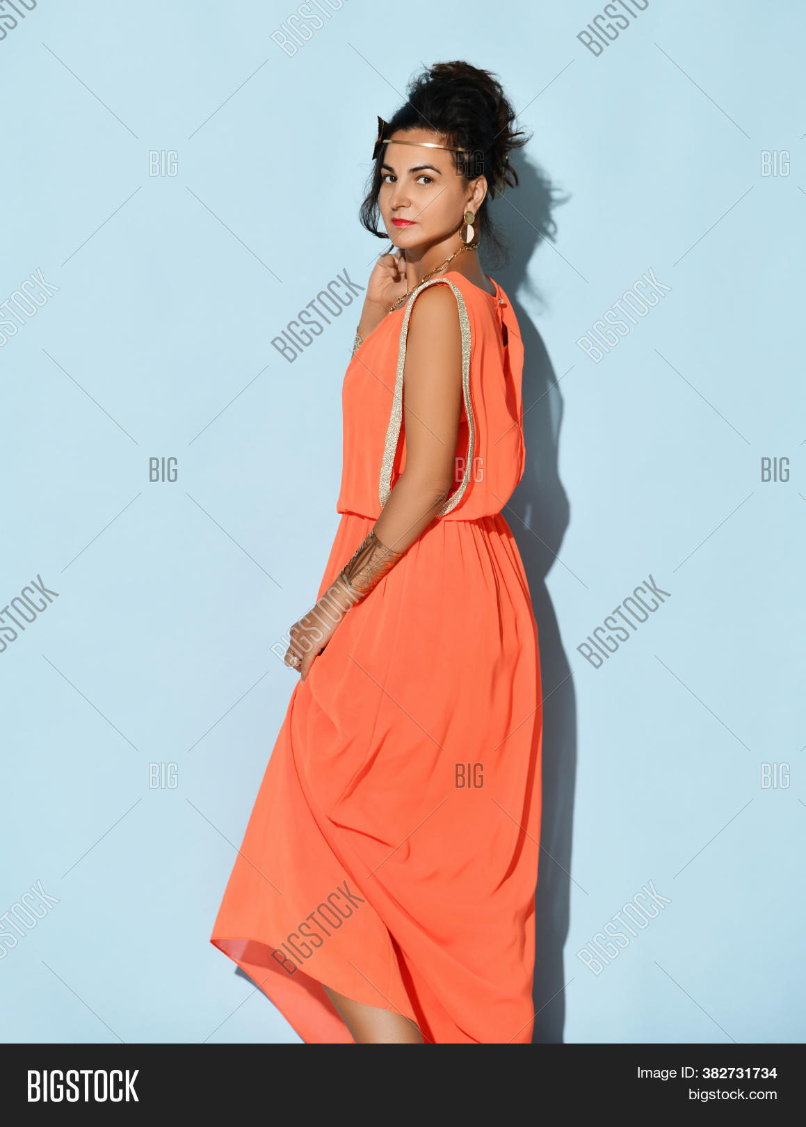 studio, 																					portrait, 																					beautiful, 																					attractive, 																					charming, 																					young, 																					brunette, 																					woman, 																					wearing, 																					greek, 																					inspired, 																					dress, 																					coral, 																					color, 																					traditional, 																					fashion, 																					bracelet, 																					earring, 																					headband, 																					jewelry, 																					female, 																					isolated, 																					blue, 																					stand, 																					full, 																					length, 																					background, 																					elegance, 																					glamour, 																					posing, 																					fashionable, 																					gorgeous, 																					sensuality, 																					vogue, 																					pretty, 																					lady, 																					model, 																					sensual, 																					coiffure, 																					fabric, 																					figure, 																					golden, 																					silk, 																					atlas, 																					gold, 																					hairstyle, 																					look, 																					satin, 																					seductive, 																					hair