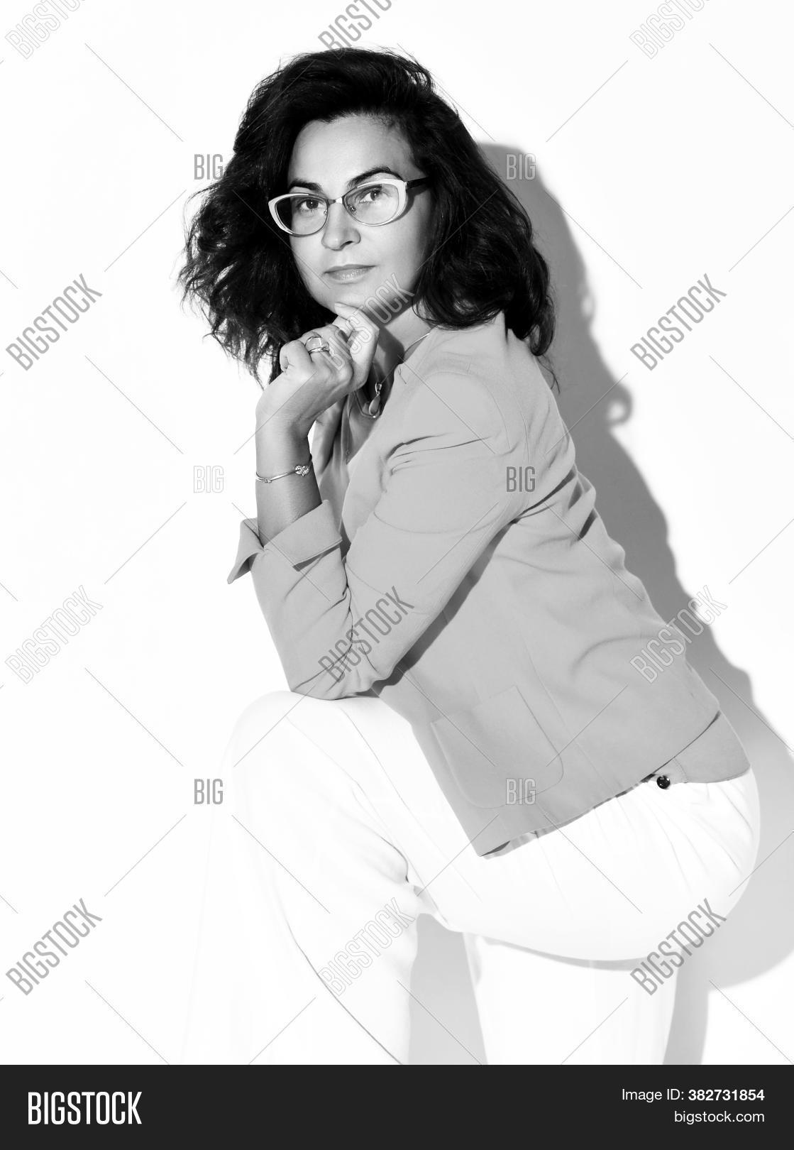 serious, 																					woman, 																					long, 																					curly, 																					hair, 																					wearing, 																					eyeglasses, 																					formal, 																					suit, 																					posing, 																					camera, 																					black-and-white, 																					headshot, 																					studio, 																					portrait, 																					white, 																					background, 																					female, 																					office, 																					style, 																					fashion, 																					person, 																					businesswoman, 																					manager, 																					professional, 																					success, 																					confident, 																					arms, 																					confidence, 																					copy, 																					space, 																					looking, 																					corporate, 																					job, 																					look, 																					secretary, 																					elegance, 																					goggles, 																					lady, 																					smart, 																					successful, 																					worker, 																					eyewear, 																					pretty, 																					accountant, 																					business, 																					caucasian, 																					brunette