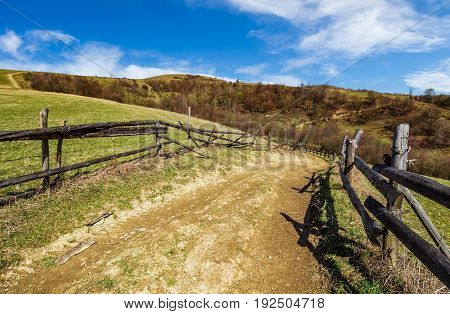 wooden fence by the road in rural area. springtime countryside ...