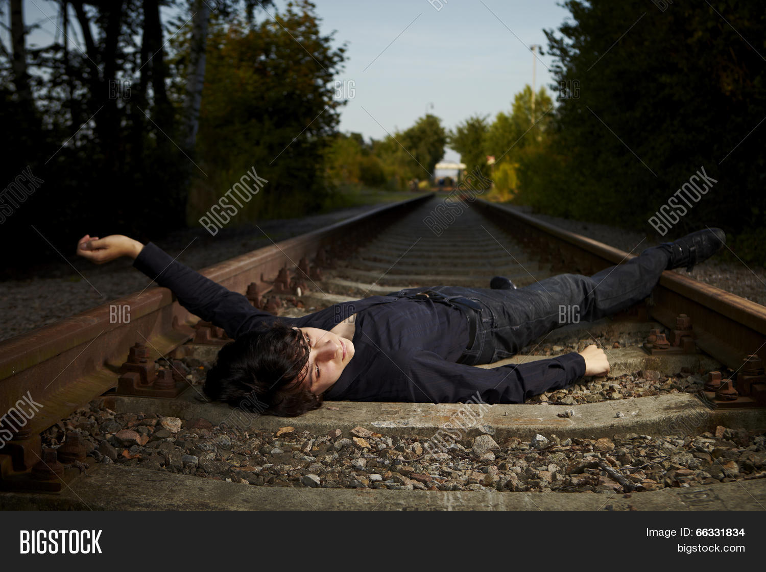 alone,bleak,blue,boy,dejection,distressed,distressful,doleful,dolorous,doomy,emotion,feelings,heartsickness,human,loneliness,lonely,lorn,male,man,outdoor,poor,railway,sad,sick,slim,sorrowful,suicide,summer,tall,thin,train
