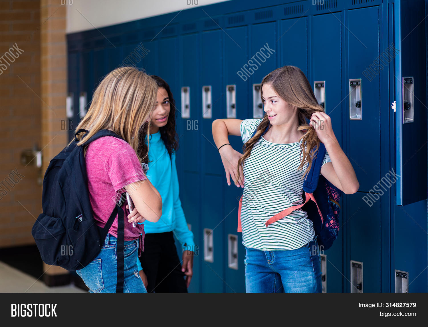 adolescence,adolescent,backpack,black,candid,cheerful,class,classmates,conversation,copy space,cute,diverse,diversity,education,enjoyment,ethnicity,female,friendly,friends,friendship,girlfriends,girls,group,hall,hallway,happy,high school,holding,horizontal,indoors,junior high school,kids,laughing,learning,lifestyle,locker,lockers,looking,middle school,public school,real,schools,smiling,student,students,talking,teen,teenage
