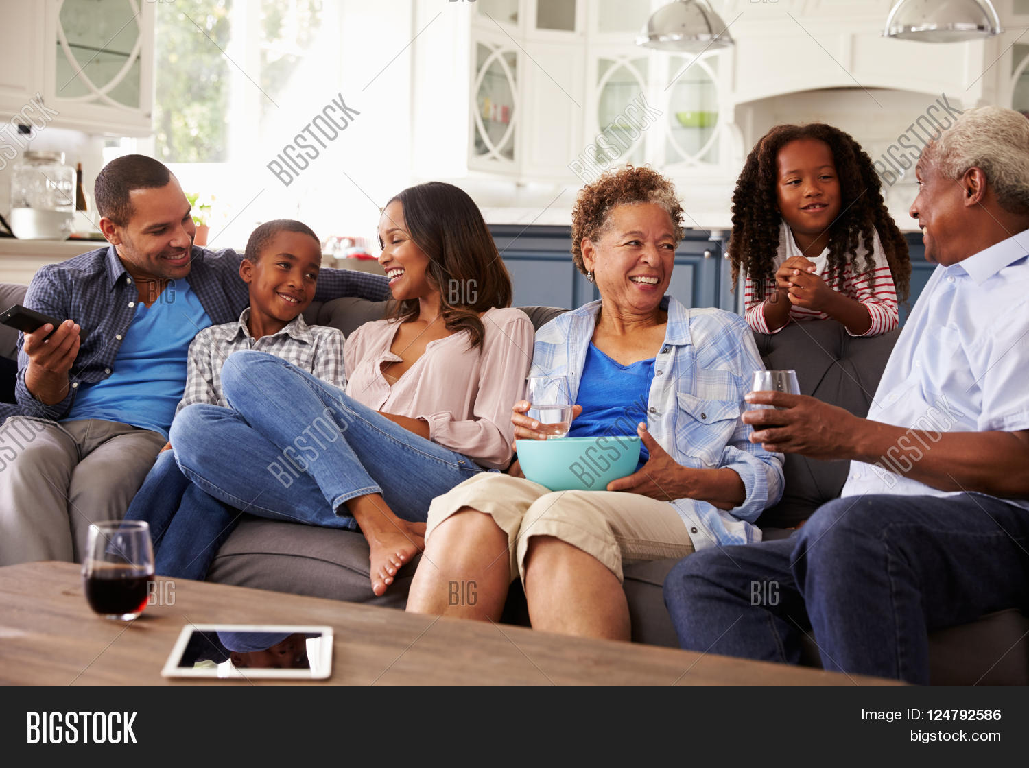 30s,60s,70s,a,activity,african,american,at,black,bonding,boy,brother,children,communication,dad,daughter,domestic,each,eating,ethnicity,family,father,front,generation,girl,grandchildren,granddaughter,grandfather,grandmother,grandparents,grandson,group,home,horizontal,in,indoors,kids,laws,leisure,length,life,looking,medium,men,millennials,mother,multi,mum,of,other,parents,people,quarter,row,seniors,siblings,sister,sitting,smiling,son,talking,three,togetherness,view,visiting,women