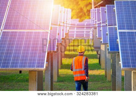 Solar Power Plant,engineers Walking In The Solar Energy Panels,technician With Field Of Solar Panels