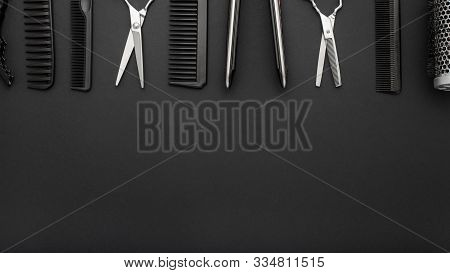 Flat Lay Composition With Hairdresser Tools: Scissors, Combs, Hair Iron On Black Background. Frame.