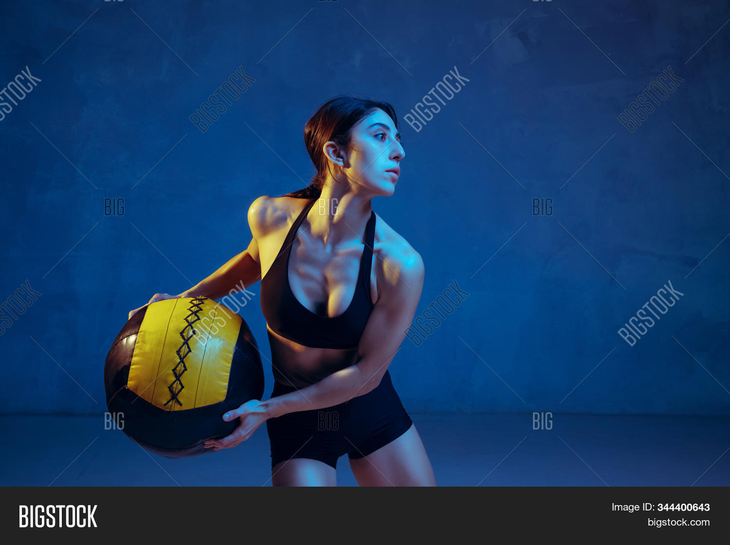 strong,weight,training,strength,sportswear,sport,person,people,muscular,young,lifestyle,healthy,fitness,lift,woman,gym,workout,athlete,fit,cross,standing,motivation,snatch,authentic,barbell,slim,body,care,preparation,practicing,club,portrait,one,indoors,exercise,female,building,focused,wellness,power,blue,neon,colored,lower,upper,abs,crunch,ball