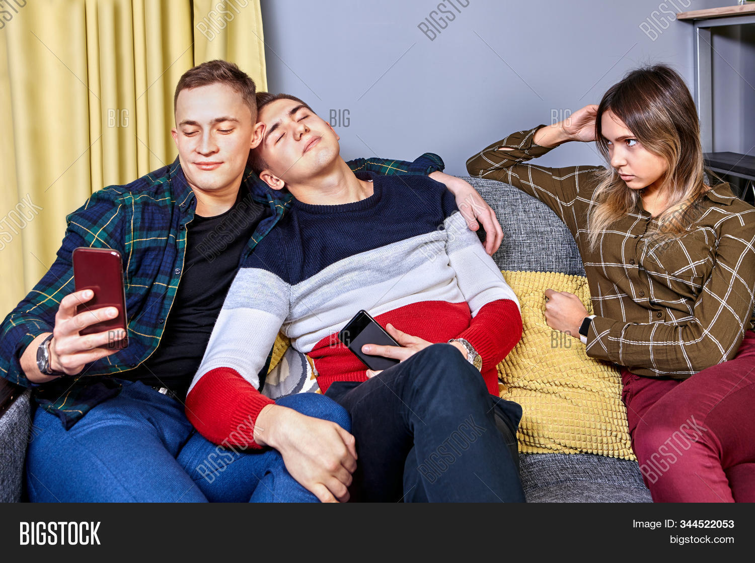 young,boy,people,sitting,male,indoors,woman,girl,female,lifestyle,love,romantic,friends,friendship,party,man,relationship,couple,student,sofa,girlfriend,boyfriend,romance,togetherness,date,meeting,brother,lovers,annoyance,together,three,contempt,tenderness,jealousy,adult,envy,homosexual,proximity,resentment,selfie,college,dorm,lgbt,same-sex,bromance