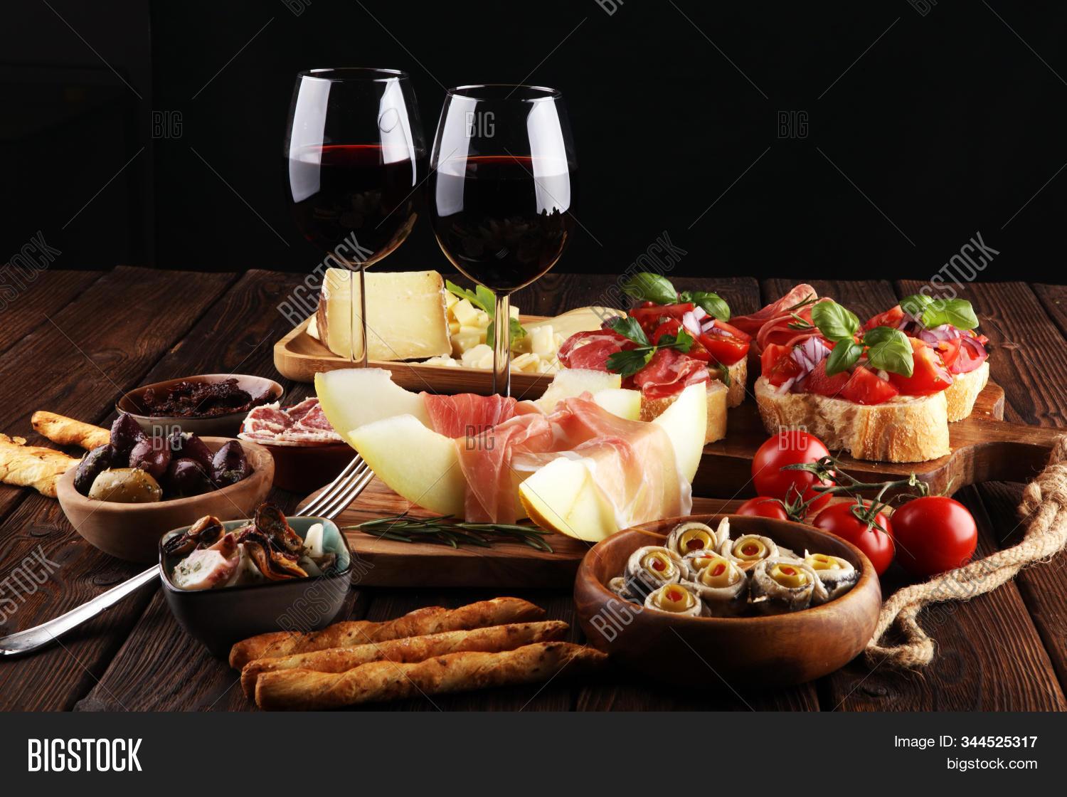 antipasto,variety,wine,food,dark,restaurant,buffet,antipasti,ancovy,seafood,italian,salami,appetizer,cheese,melon,prosciutto,set,grunge,gourmet,delicatessen,rose,glass,olive,brushetta,meal,snack,board,pickle,bruschetta,fresh,dinner,fruit,drink,wooden,cuisine,meat,alcohol,tapas,bar,traditional,bread,spanish,delicious,tasty,eating,rustic,canape,oil