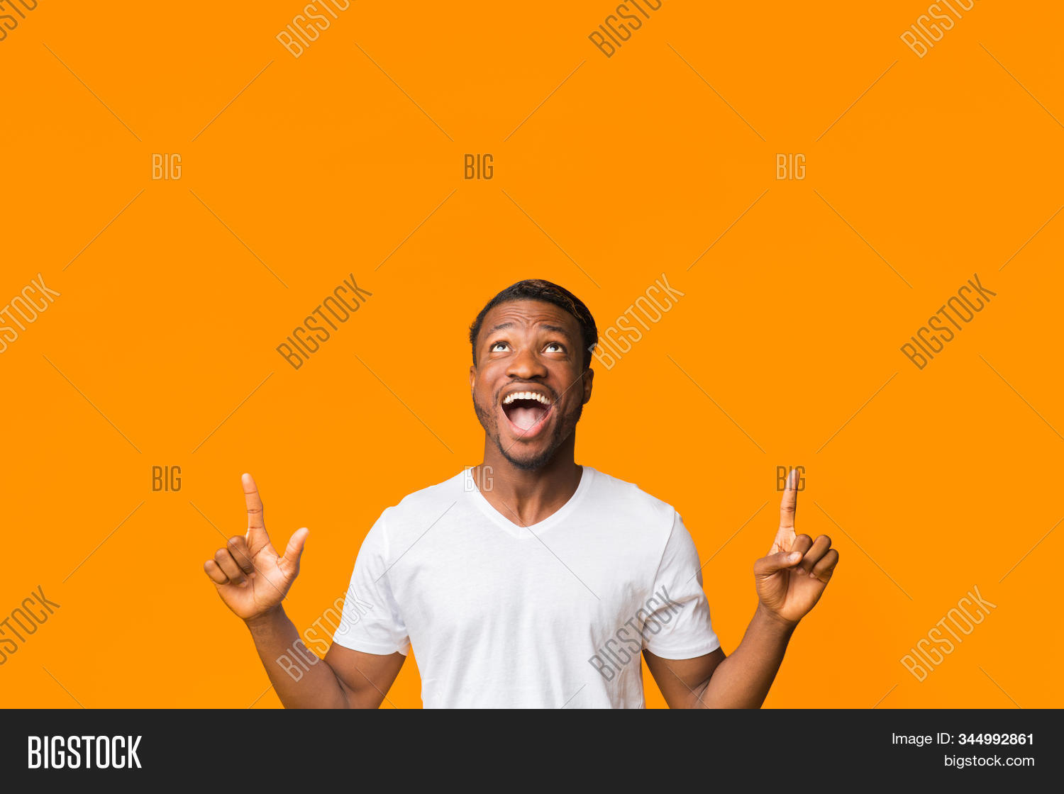pointing,advertisement,standing,approve,guy,excitement,direction,adult,person,ad,banner,orange,man,masculine,showing,20s,look,one,excited,afro,posing,up,funny,positive,black,upward,expression,studio,concept,30s,toothy,hands,gesture,millennial,male,smiling,casual,fingers,handsome,emotion,recommend,background,happy,young,people