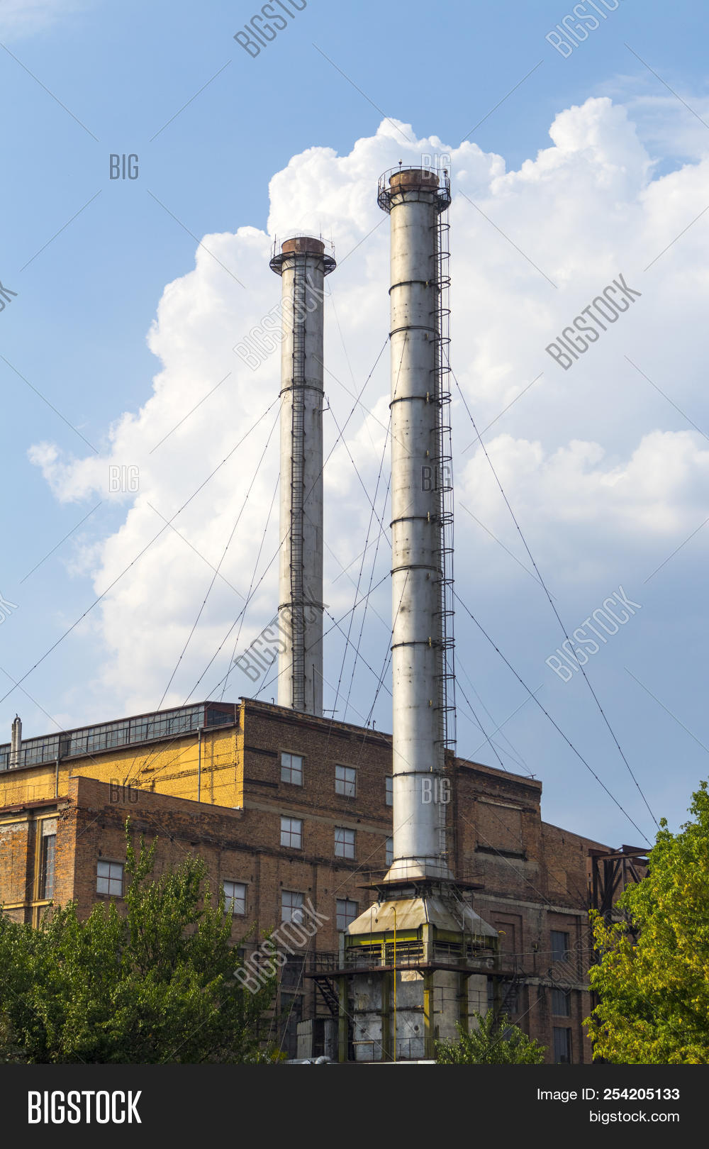 august,blue,bricks,buildings,chimneys,clouds,construction,energy,engineering,environment,factory,high,industrial,industry,metal,no,nobody,people,pipes,plant,power,production,red,sky,stack,stalk,station,steel,stretch,structure,summer,tall,technology,trees,two,windows