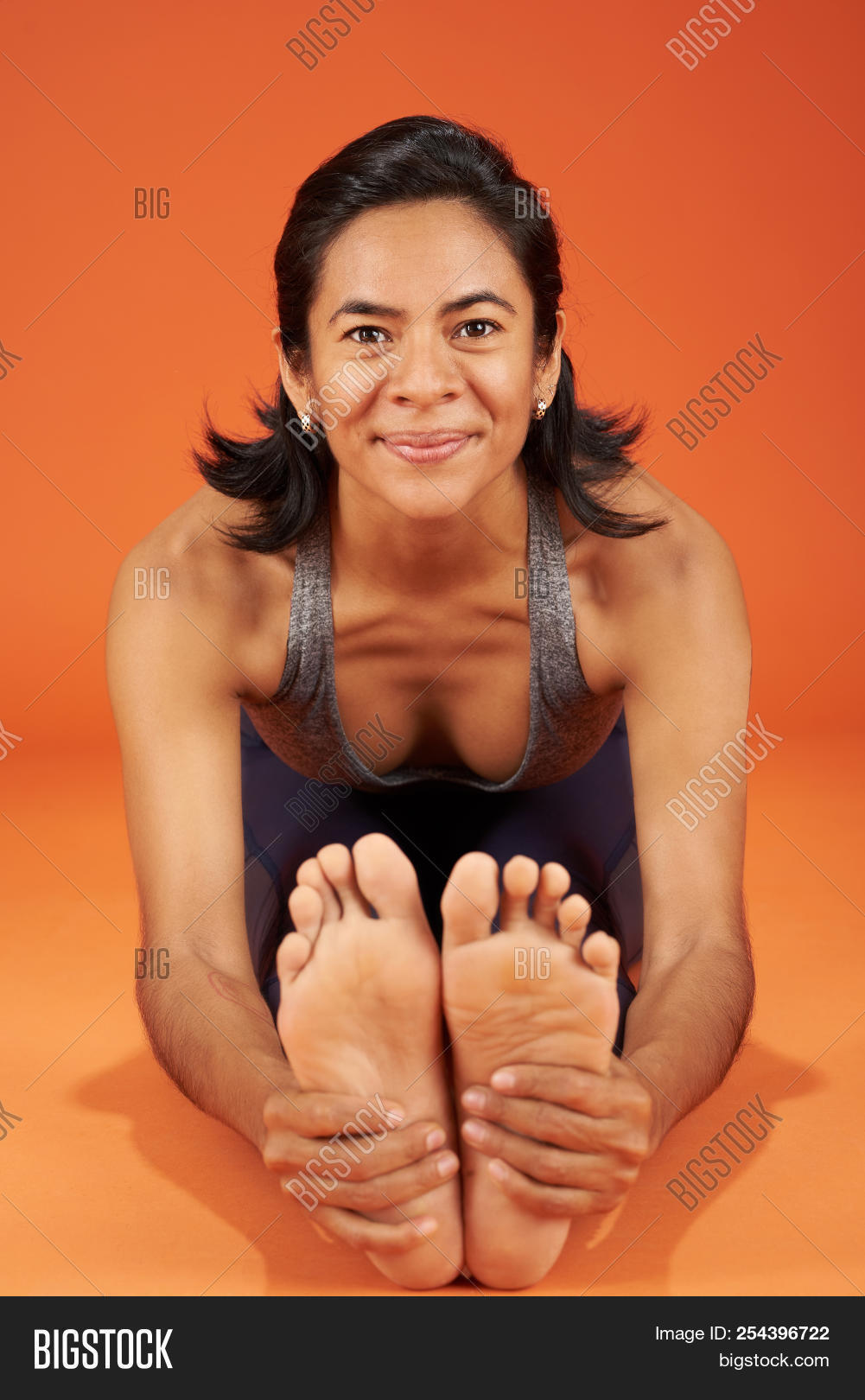 Bend,Forward,Seated,active,activity,adult,asana,attractive,background,balance,beautiful,beauty,body,doing,exercise,female,fit,fitness,gym,health,healthy,hispanic,latina,lifestyle,muscle,one,orange,people,person,pilates,pose,practice,slim,sporty,studio,training,wellness,white,woman,workout,yoga,young
