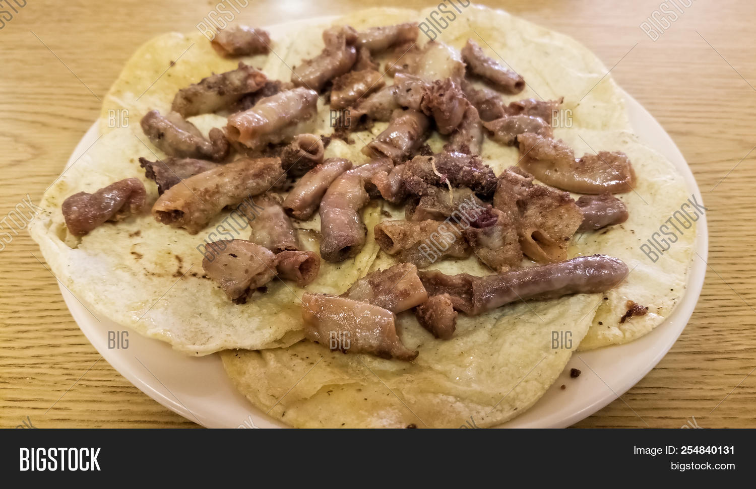 appetizer,beef,bread,brown,chunchulo,chunchurria,close-up,closeup,cooked,cuisine,de,delicious,dinner,dish,eating,epicurean,food,fresh,gourmet,health,healthy,isolated,lunch,meal,meat,mexican,nutrition,plate,roast,rustic,sauce,stews,table,taco,tasty,texas,tortillas,traditional,tripa,tripitas,typical,usa,white,wood,wooden